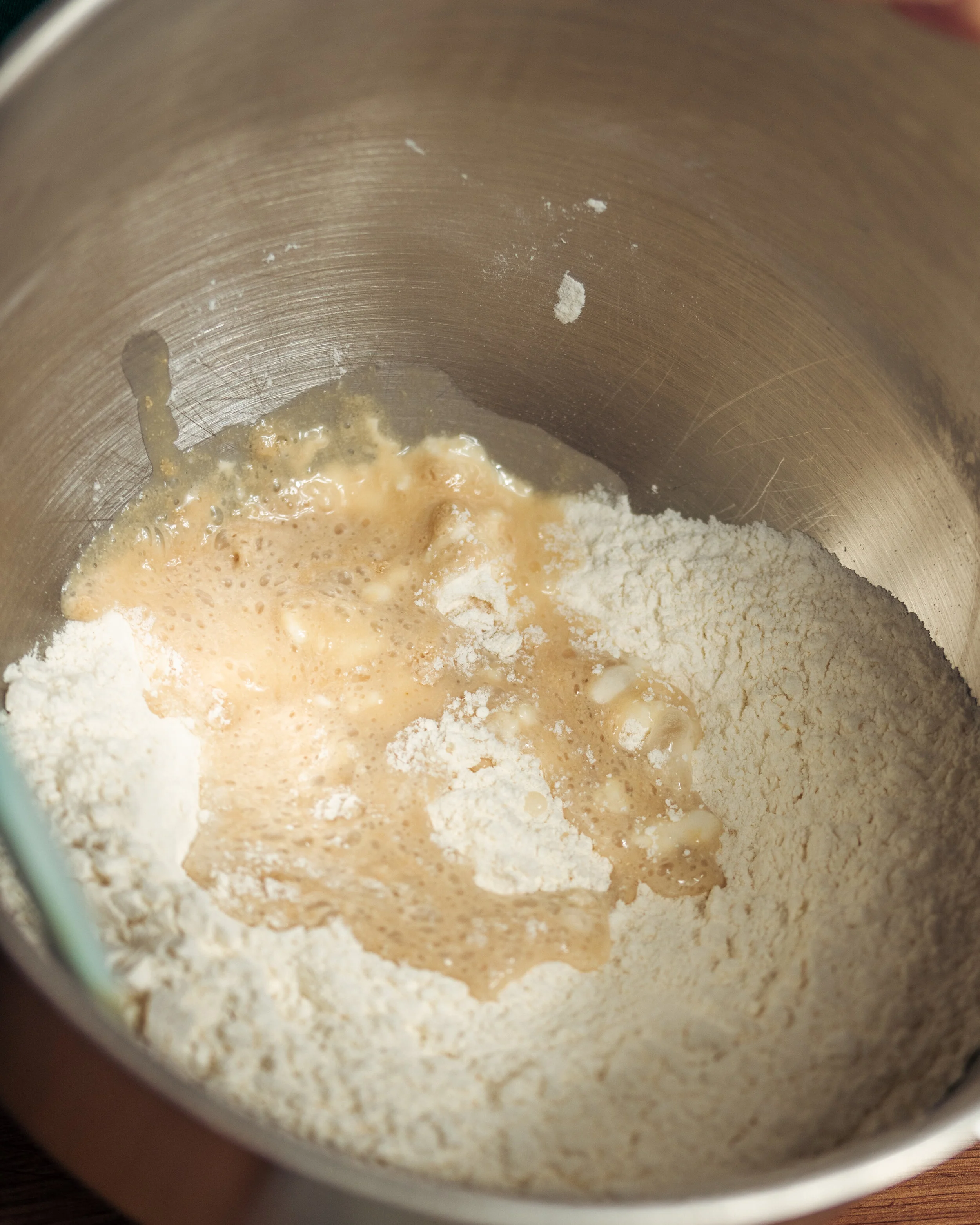 Once the yeast foams, add it to the dough.