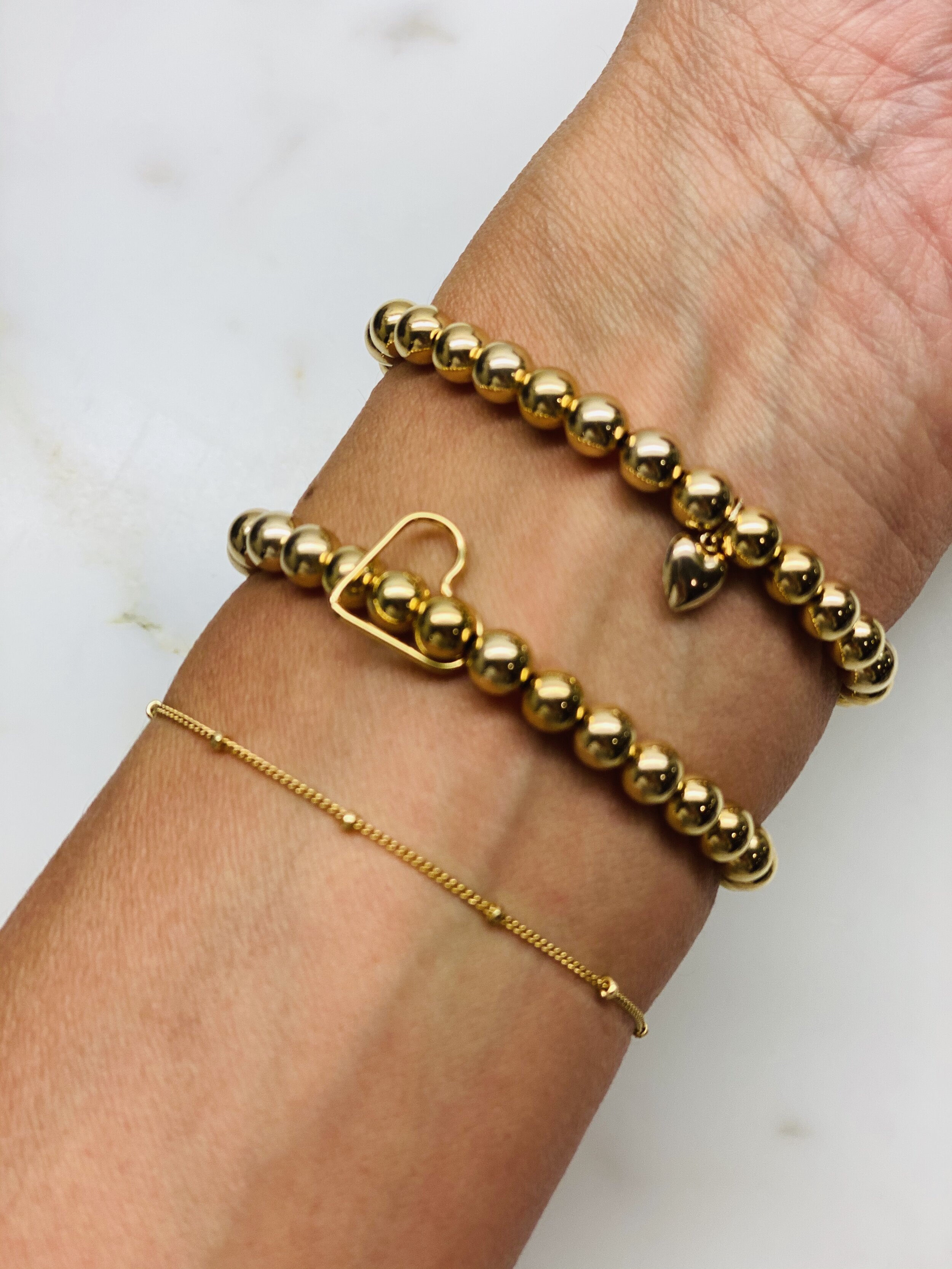 Our Gold filled lucca bracelet paired with other bracelets.