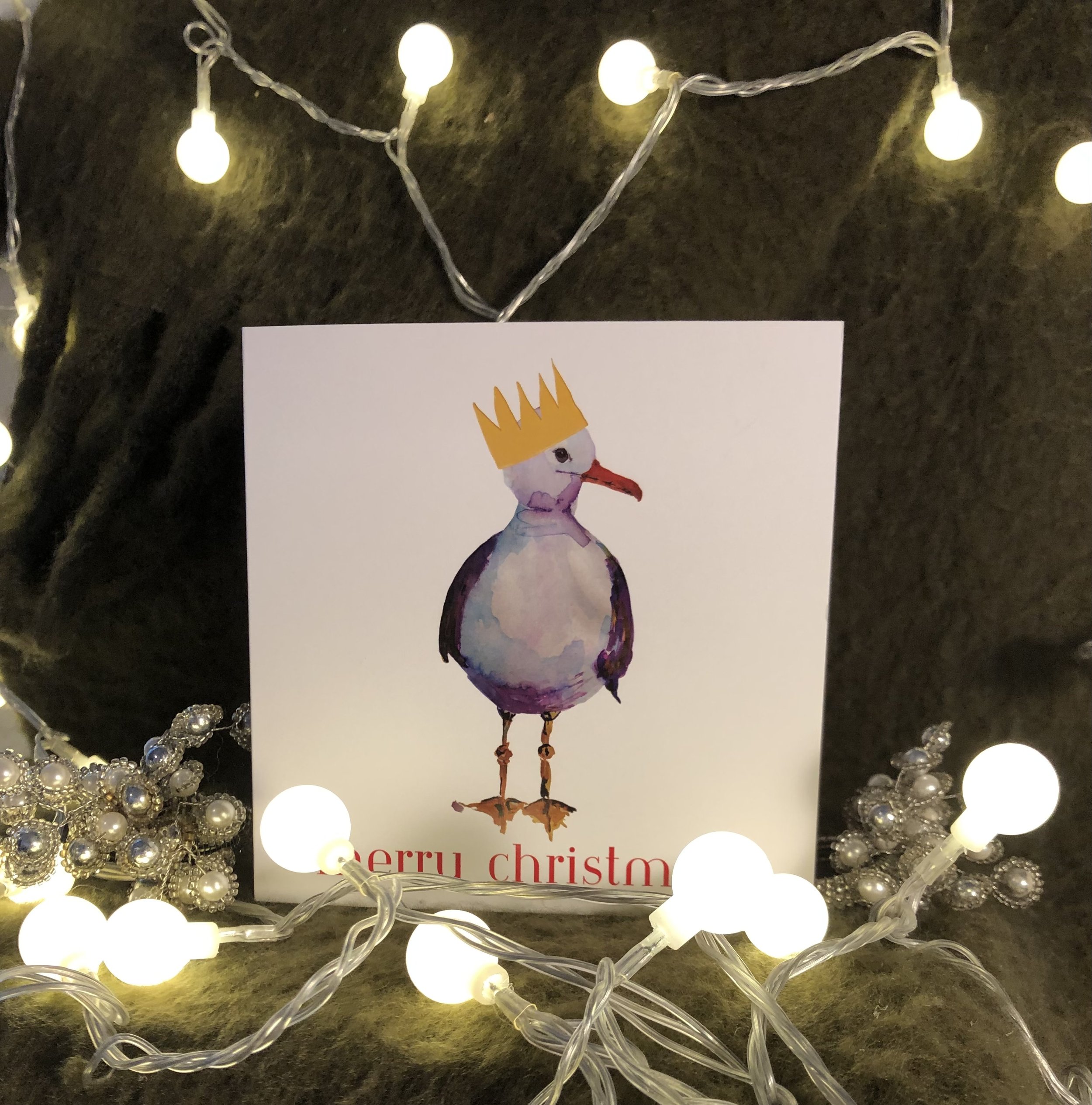 Seagull wearing a paper crown