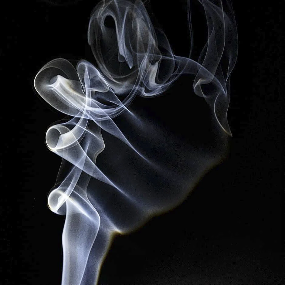 Swirling white and gray smoke against a black background.