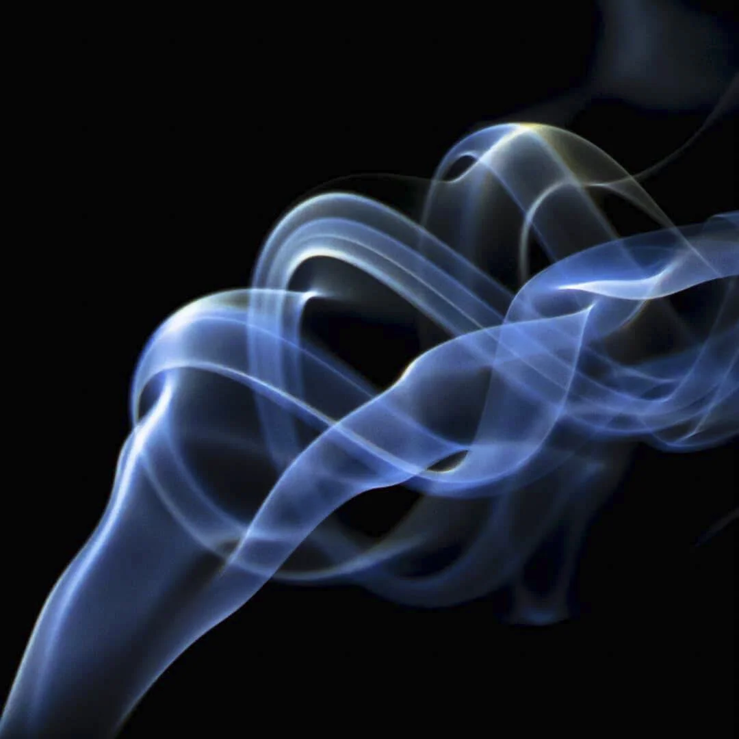 Blue and white wisps of smoke or vapor against a black background.
