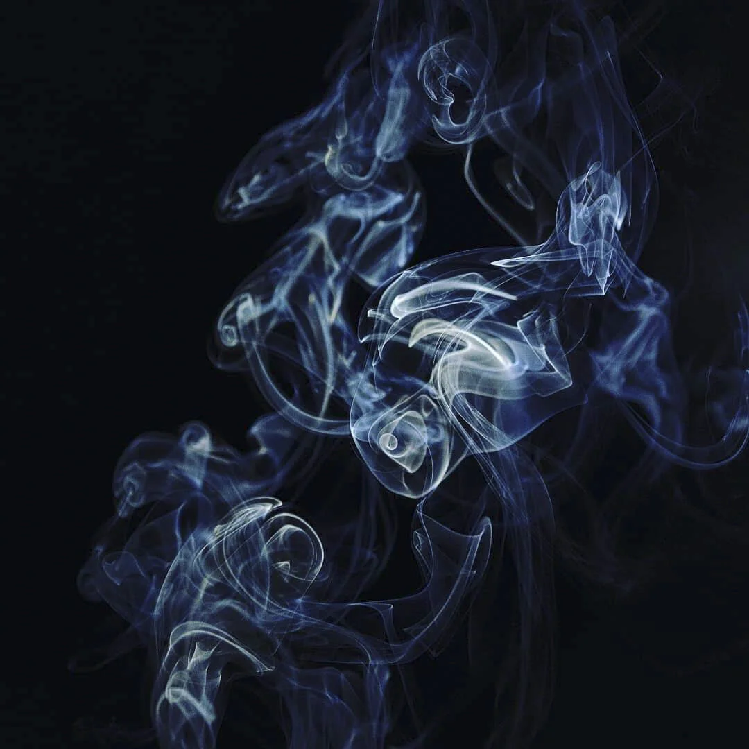 Swirling wisps of blue and white smoke against a black background.