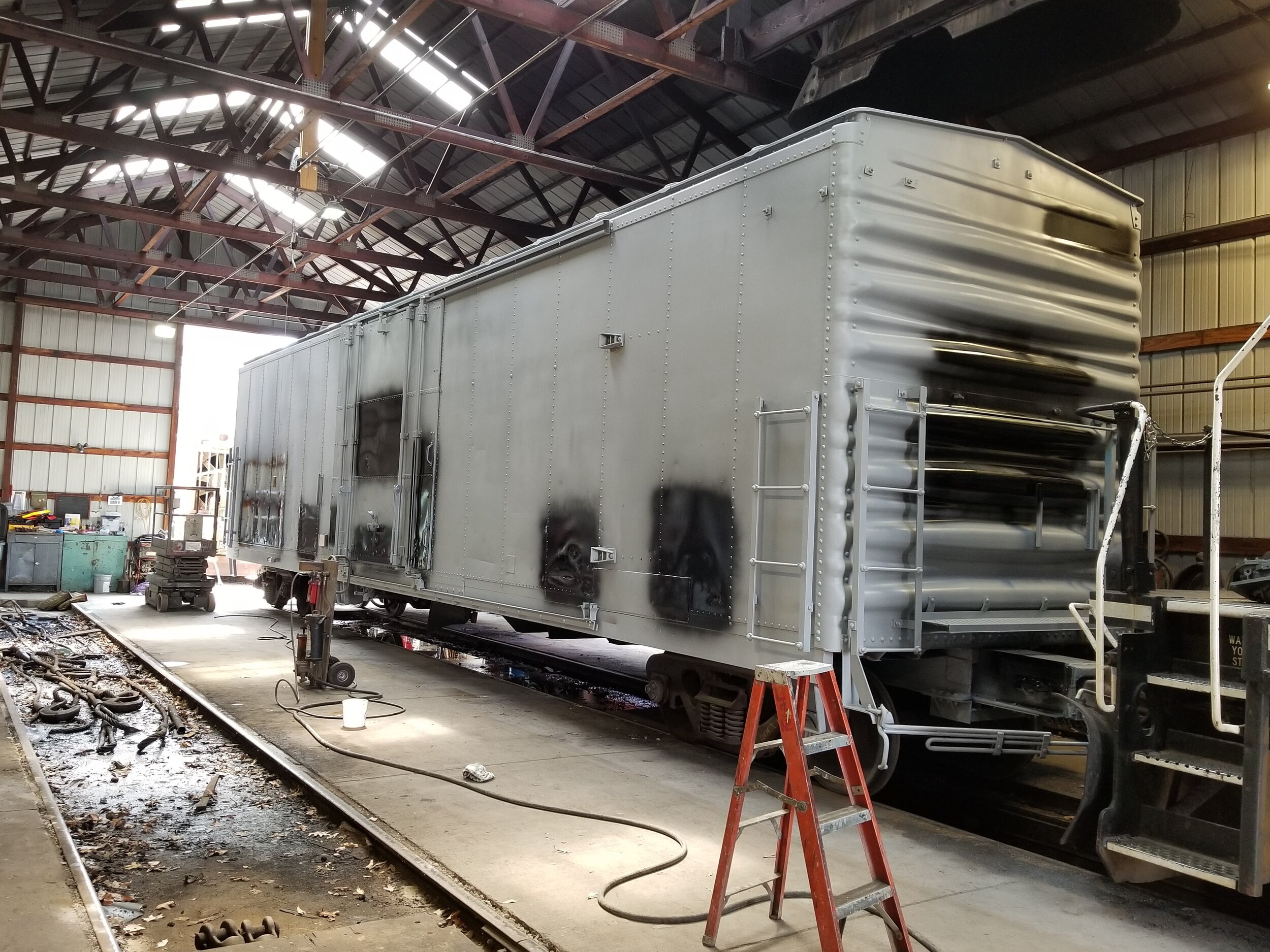  After primer, black paint is applied everywhere there is lettering and other car info. 