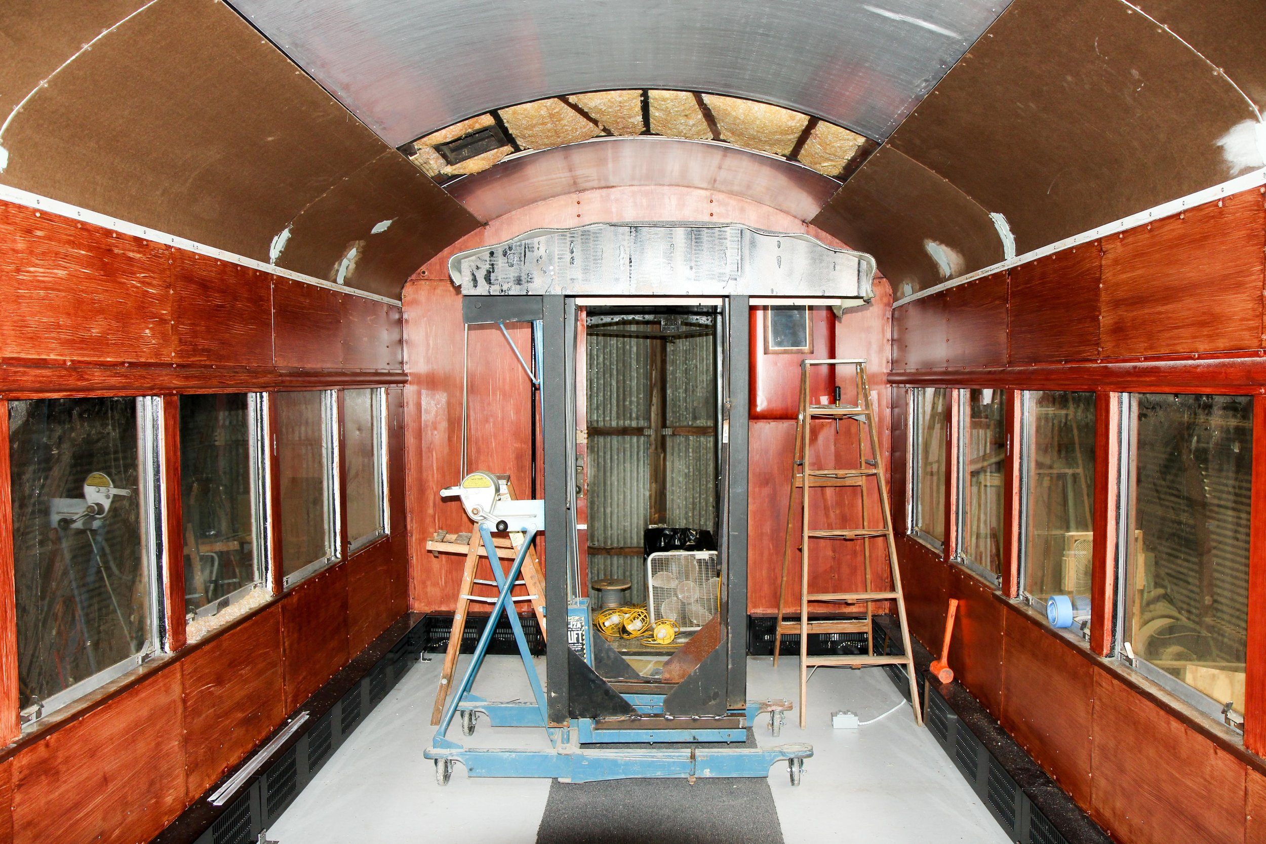  Once painting the faux wood paneling was complete, volunteers began to install the ceiling panels. Our creative volunteers created a jig to make installing the panels easier and more efficient.  