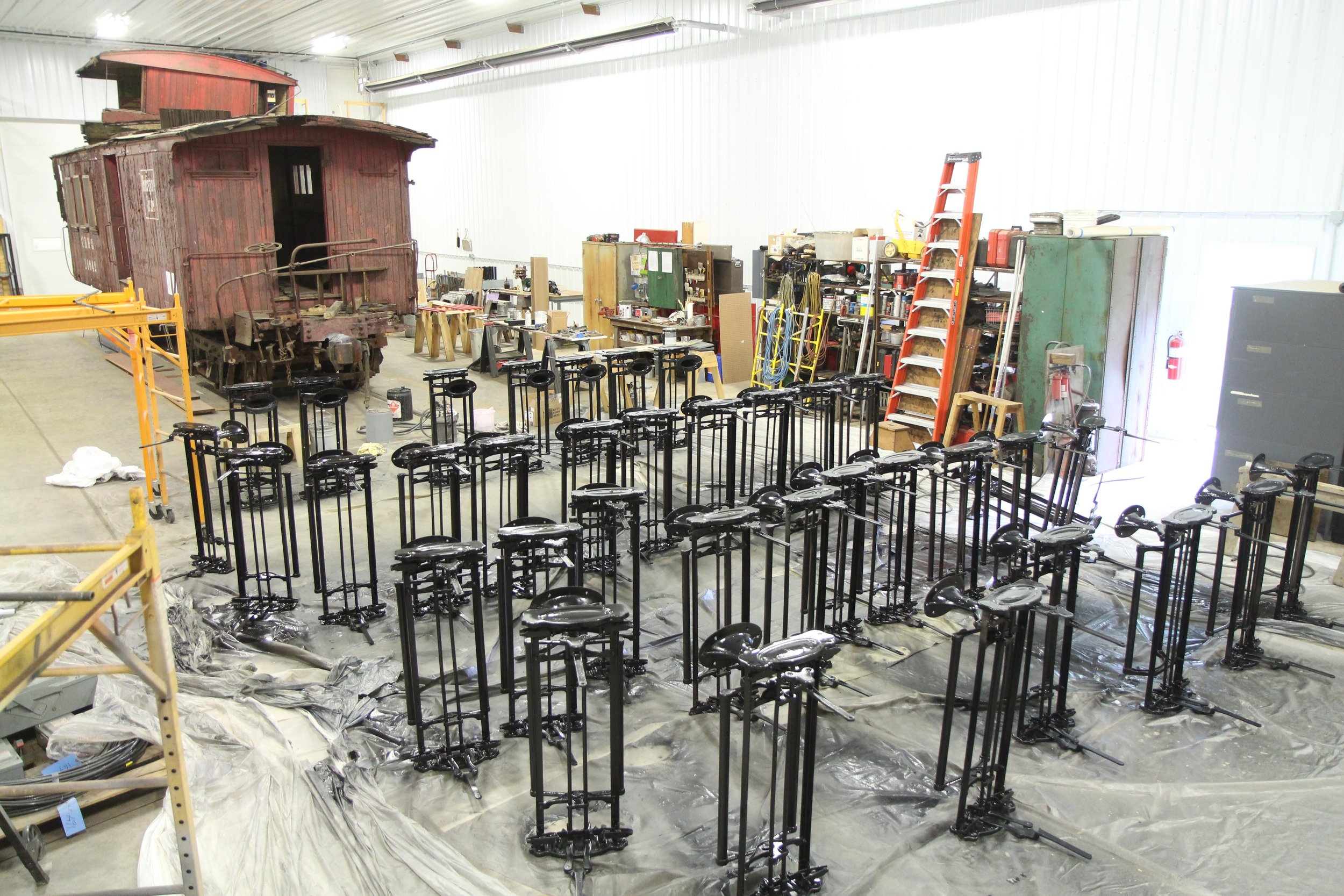  After sandblasting, the seat frames were painted. Here they are laid out in the car shop before reassembly begins.  