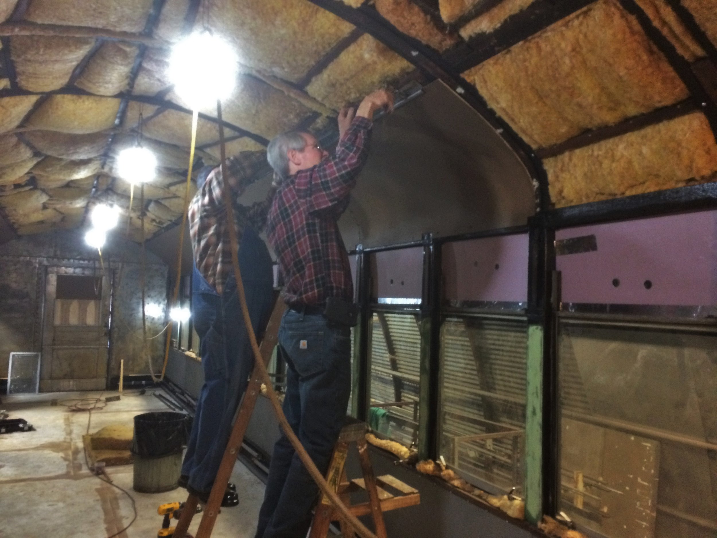  Volunteers began installing new ceiling panels.  