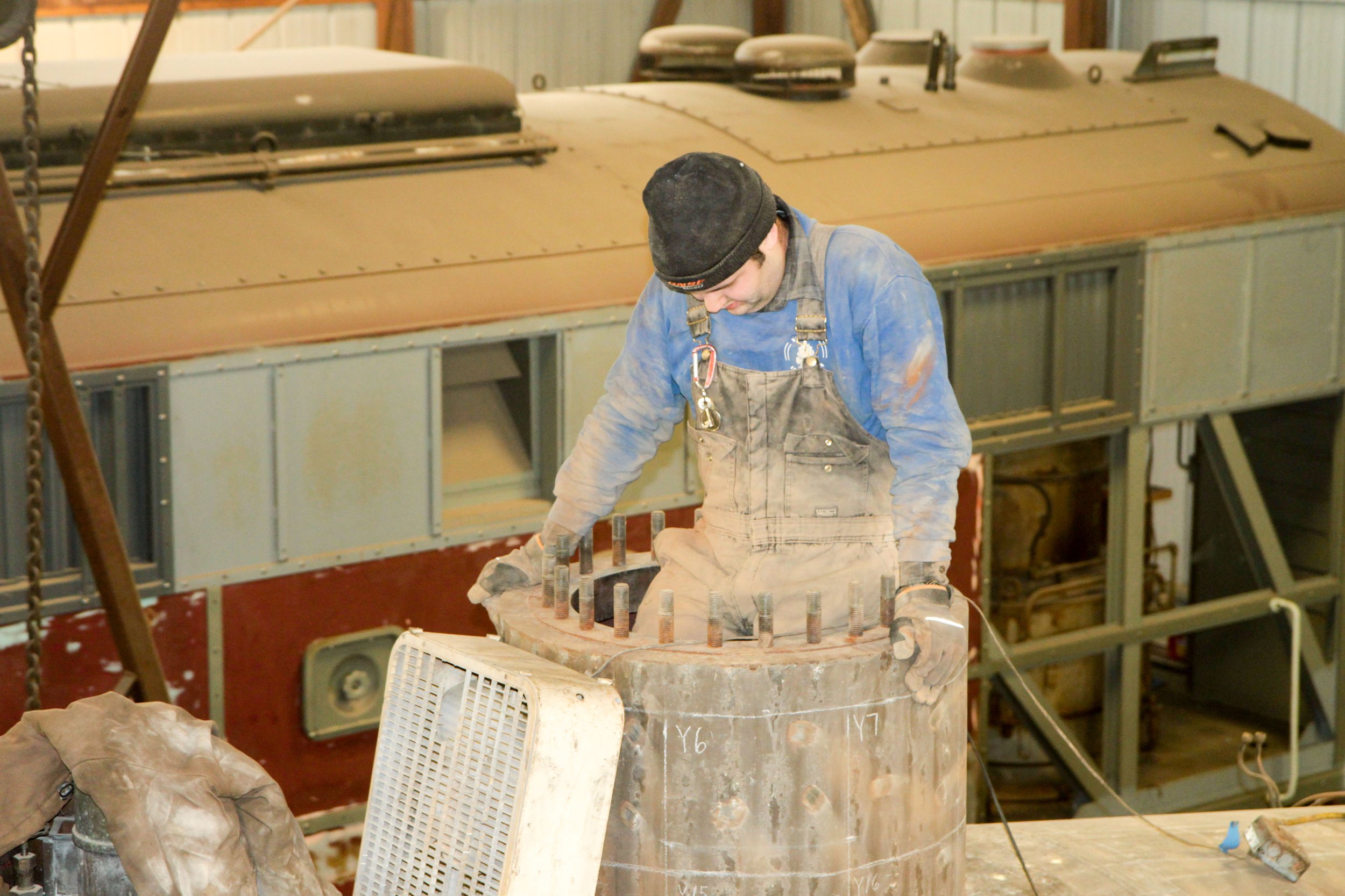  To perform the boiler inspection, volunteers needed to remove all of the boiler tubes. In preparation for this task, volunteers have to crawl inside the boiler to begin cutting them out.  