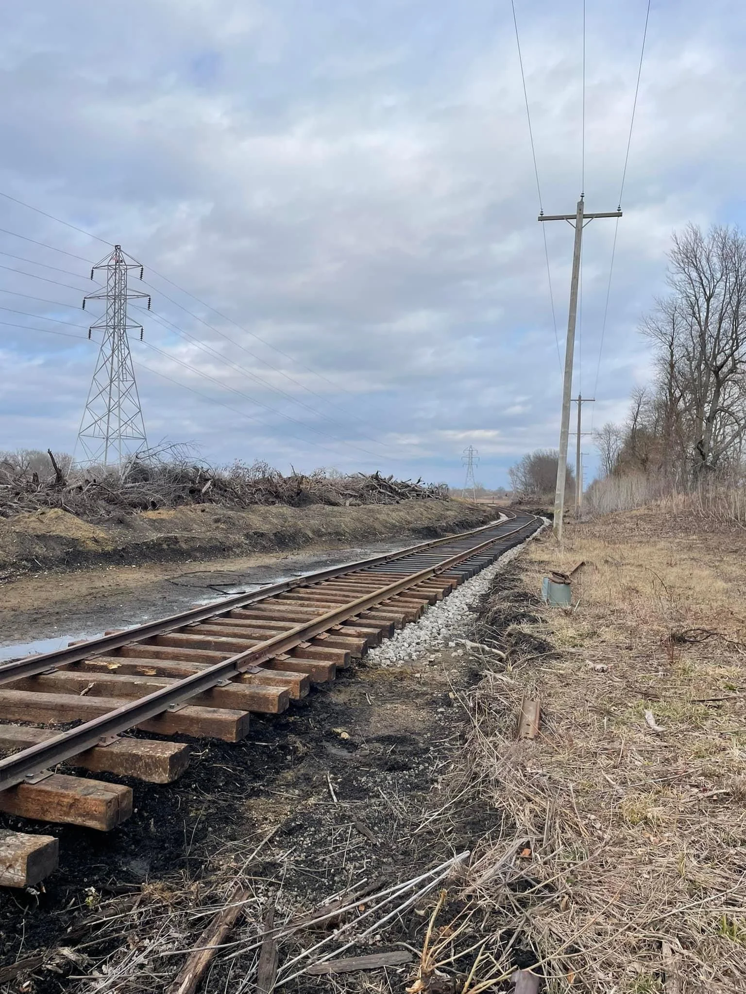  Track has now been extended over the newly constructed grade as the crossover track nears being connected to the IC main. The ties and rail have been placed and spiked together, or "skeletonized" in rail construction terminology.  