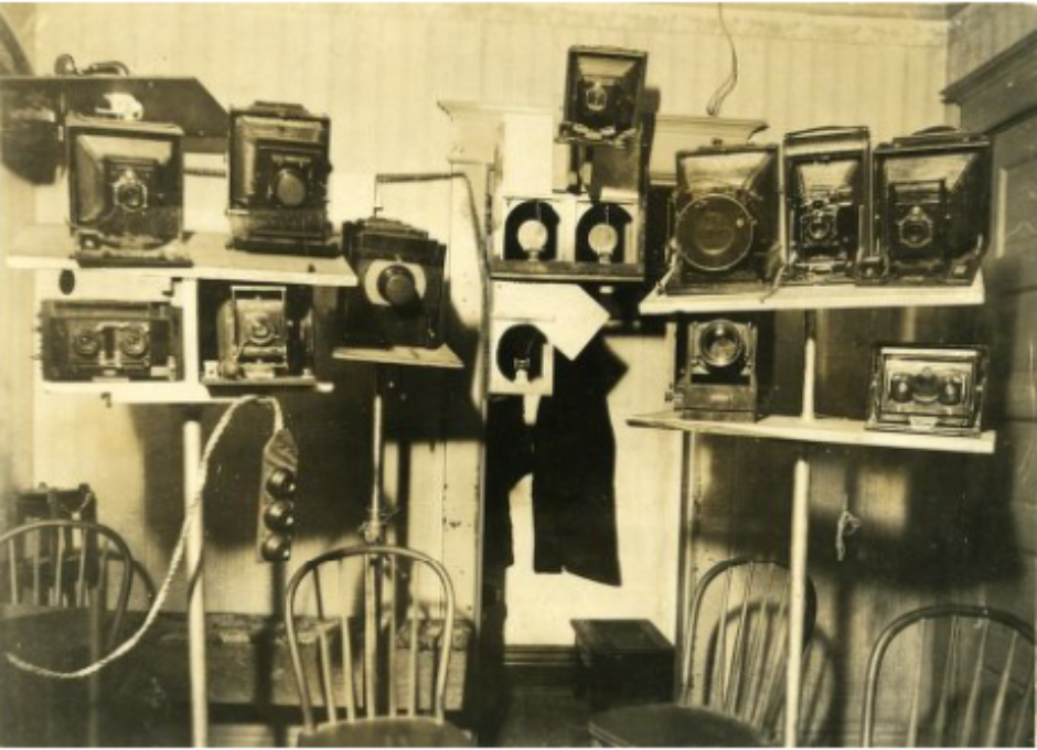 A battery of cameras covers one wall of the seance room in T.G. Hamilton's home.png