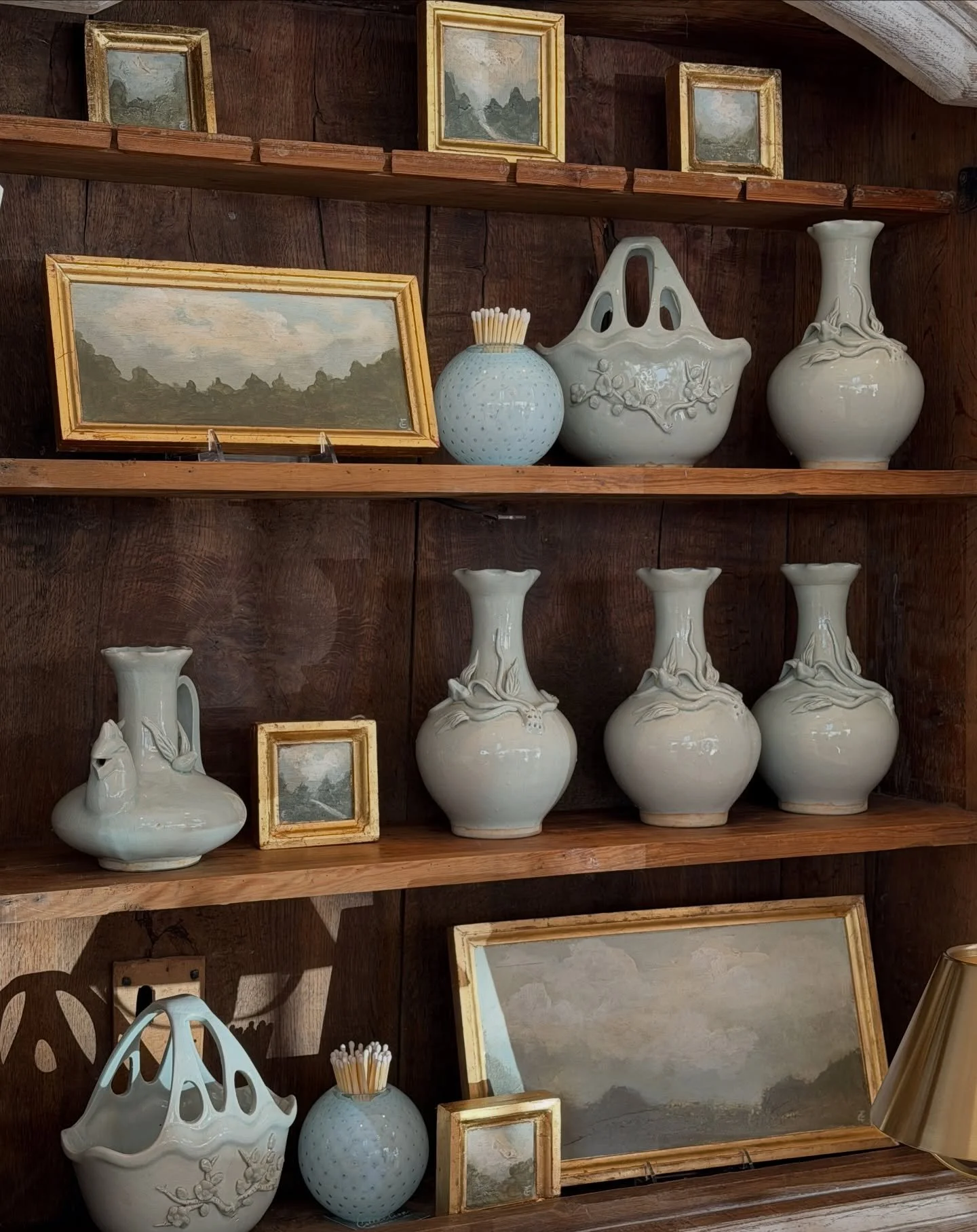 An heirloom cabinet filled with peaceful scenes.

Hand-finished ceramics, gilded frames, and soft blues layered beside our pair of Mariano Antique Chairs.

Mariano - 25.5&rdquo;W x 37.5&rdquo;H x 23&rdquo;D - $1,365 Each 

Ernst - 43.5&rdquo;W x 77&r