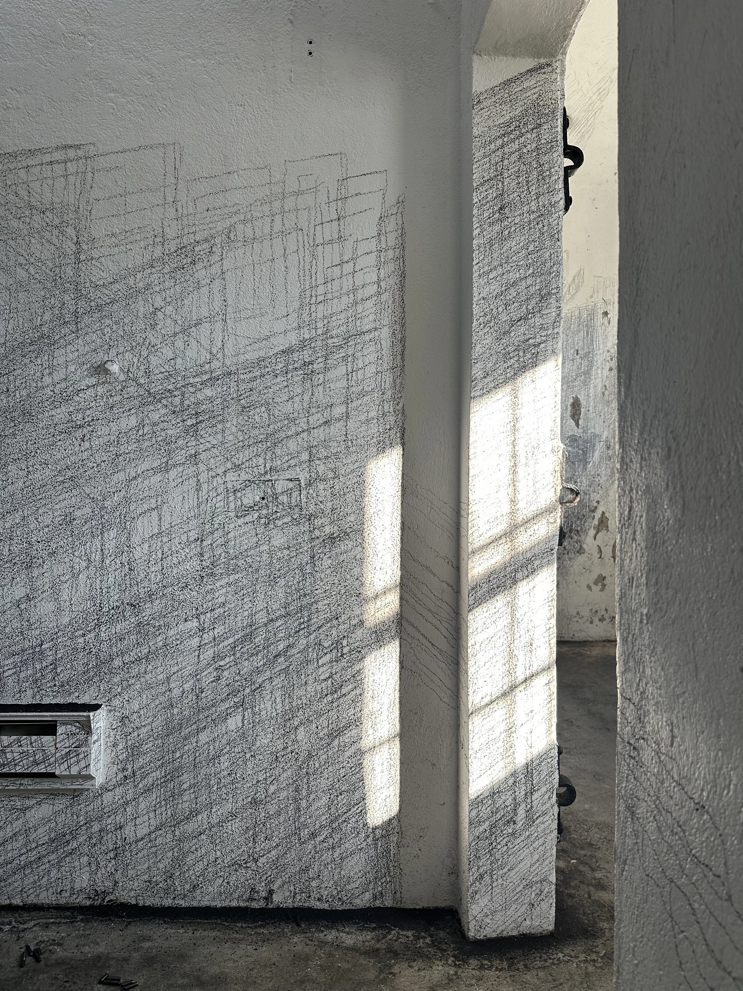 Holding On to Something Gone, 2026, Graphite on walls, sun, Dimensions variable
