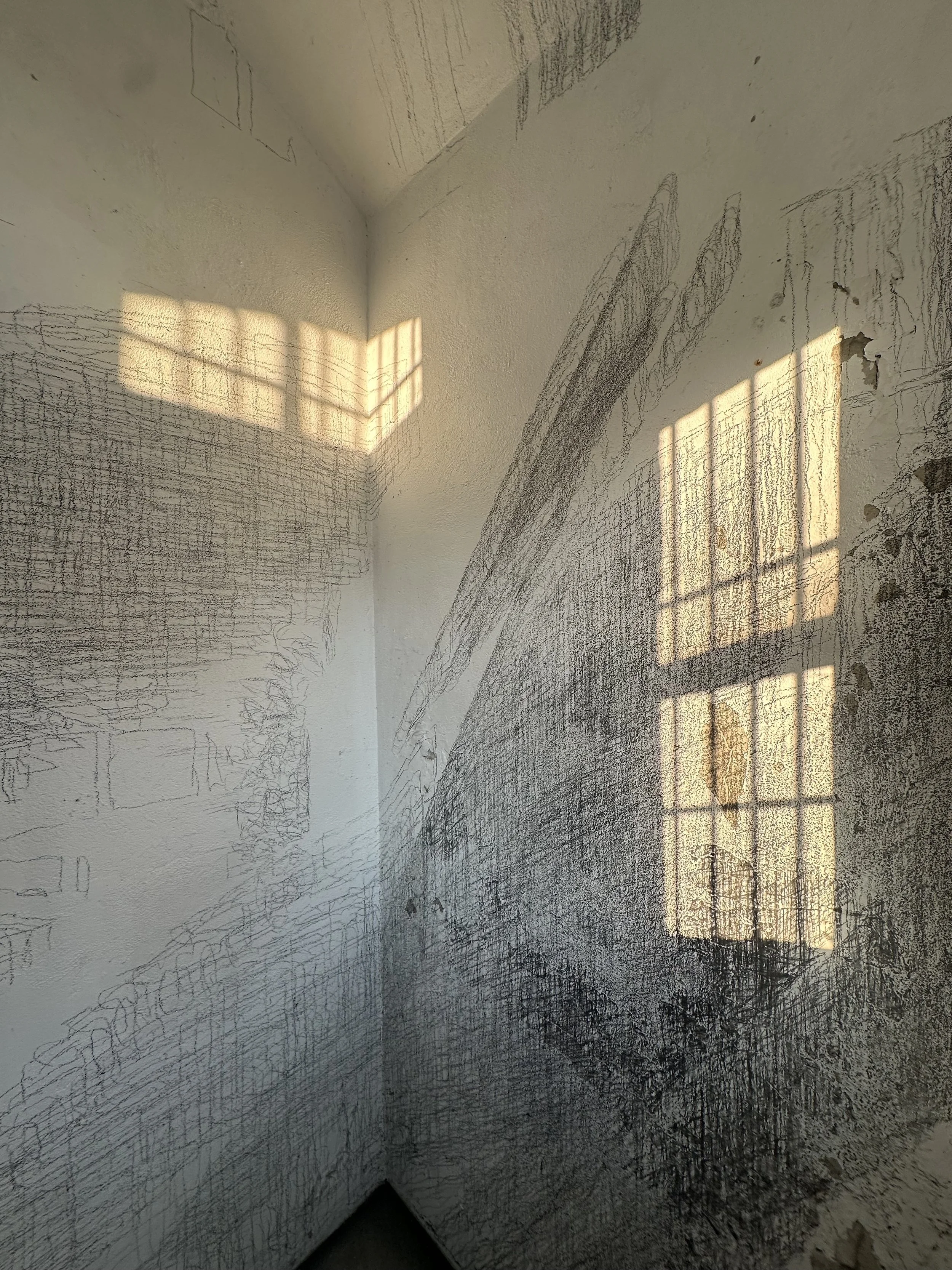 Holding On to Something Gone, 2026, Graphite on walls, sun, Dimensions variable