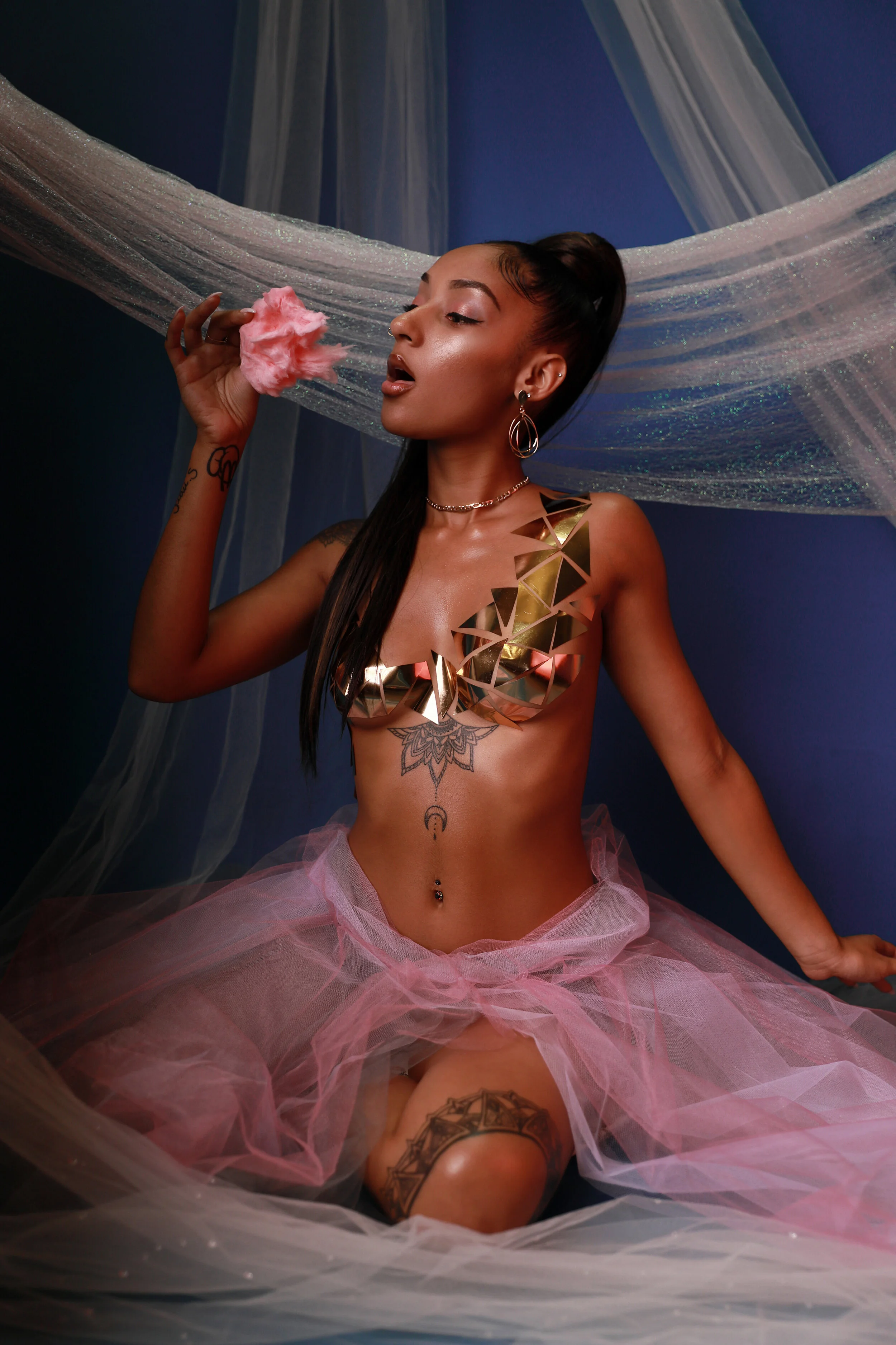 Model with gold metallic tape styling and a tulle skirt, draped silk fabric backdrop — cotton-candy concept, KEN X KEEN Orlando