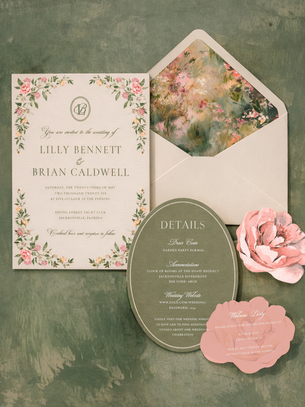 Wedding invitation set with floral designs, including an invitation card, an oval details card, a pink flower, a pink welcome card, and a floral-patterned envelope.