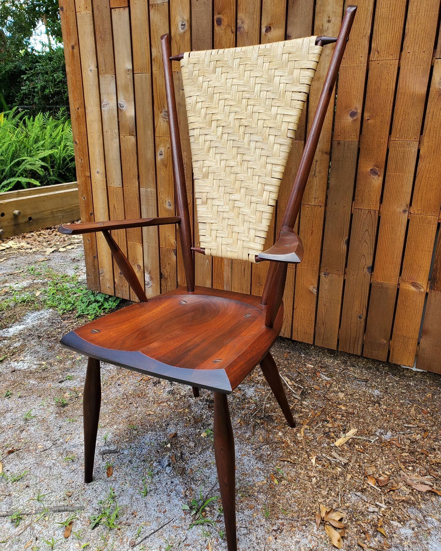 Arm chair version of Curtis's Mantis chair in walnut with a reddish-brown stain &amp; glaze. I like how the lighting really plays with the color. Flat reed back with a light walnut oil varnish 
#chairmaking #windsorchair  #chairweaving #woodgrain #wo