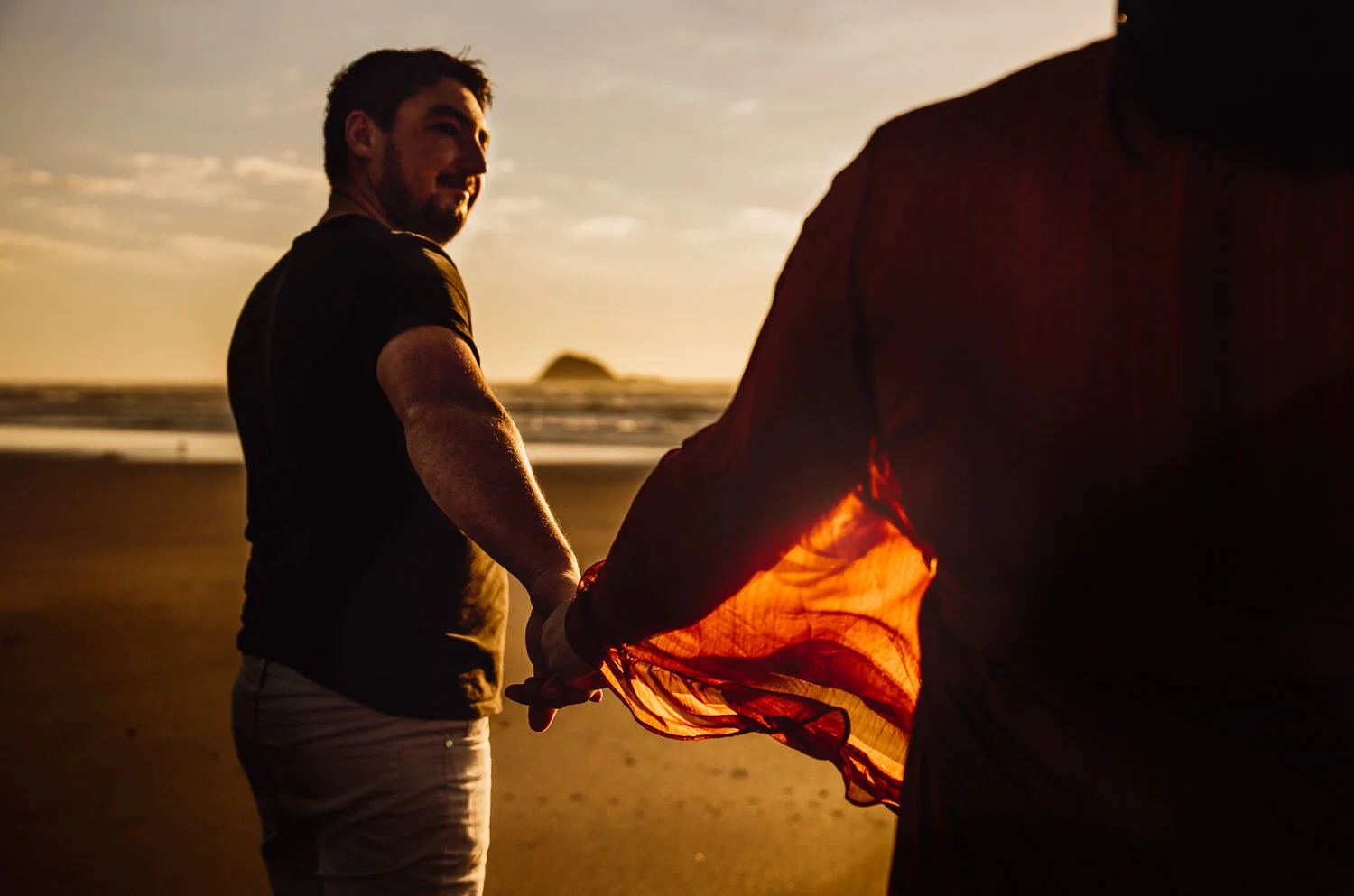 A couple embrace with with shadows on their faces at an auckland maternity session-2.jpg