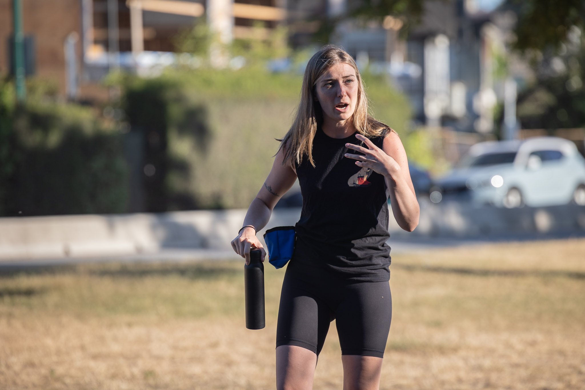 Kris, Raintown's Head Trainer, leads an outdoor dog training class at Kits Beach.