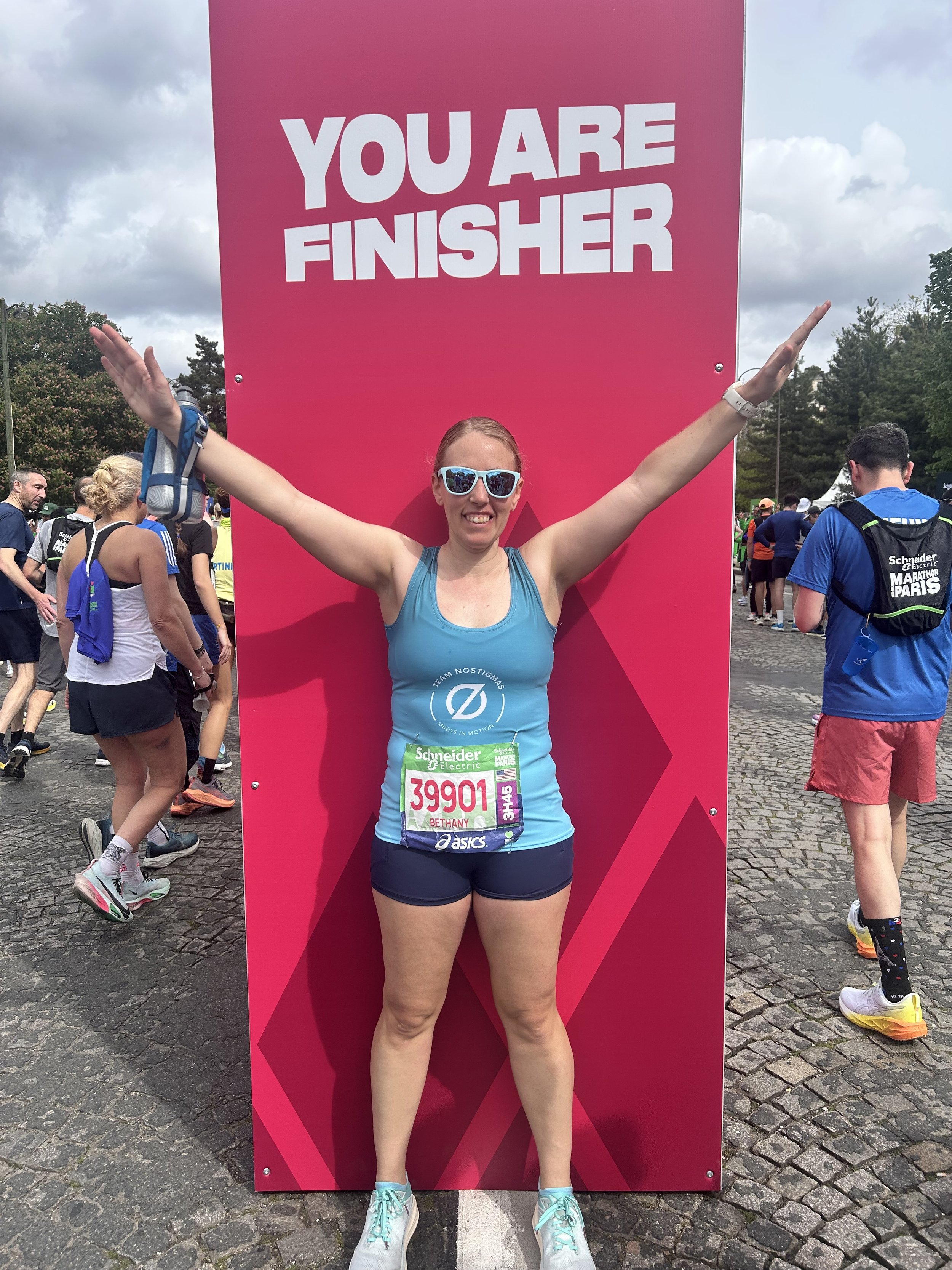 Just after I crossed the finish line of the Paris Marathon! We had to carry our own water bottle or wear a hydration vest as they did not have cups at aid station for hydrating during the race. I was also 1 out of 57, 464 finishers of this marathon!