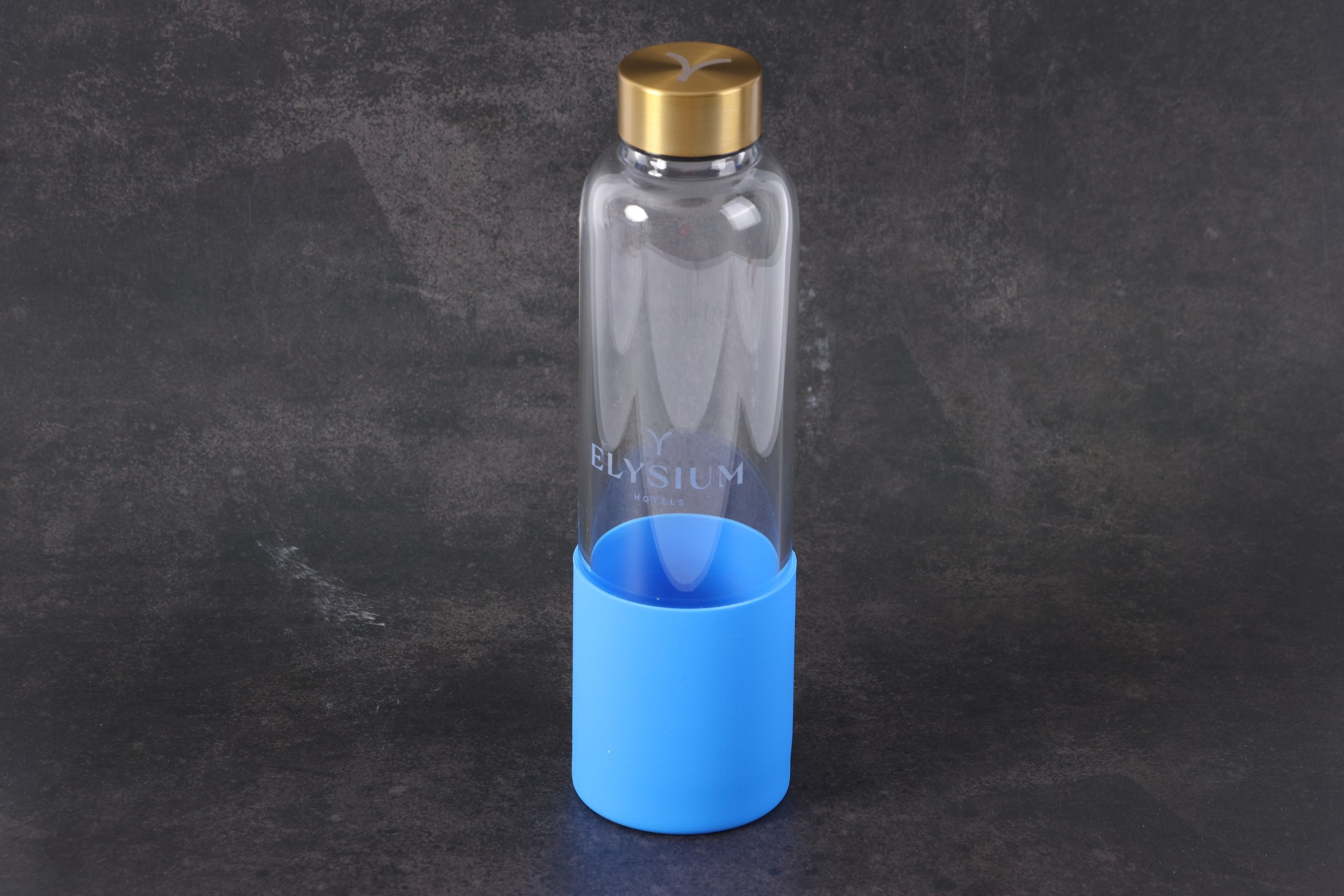 Custom Branded Glass Drink Bottle with Gold lid and blue silicone sleeve
