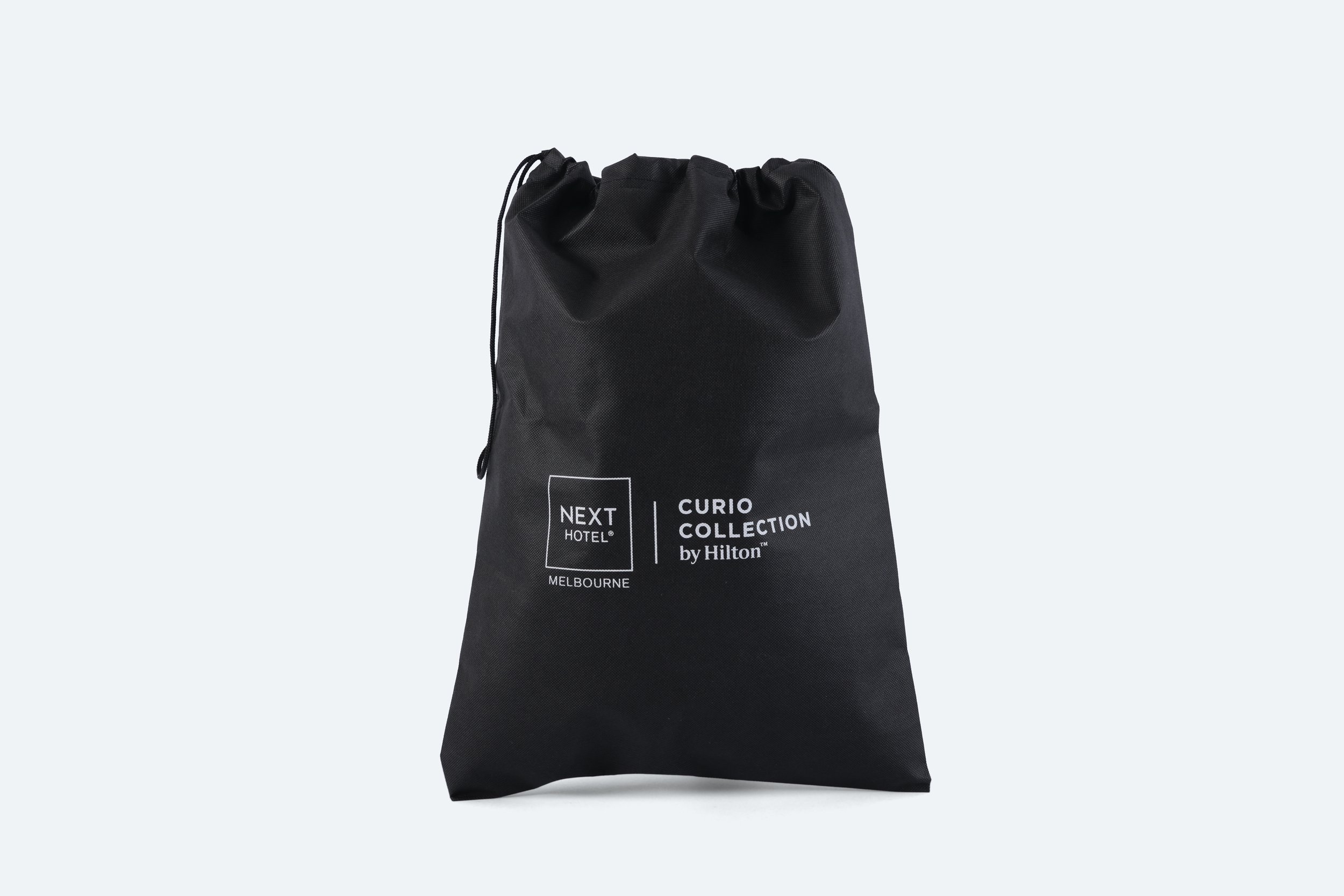 NEX001 - bag-laundry-black-nonwoven-drawstring-white-print-logo-premium-hotel-product-specialists-creation-custom-design-develop-deliver-consultantspr-final-4.JPG