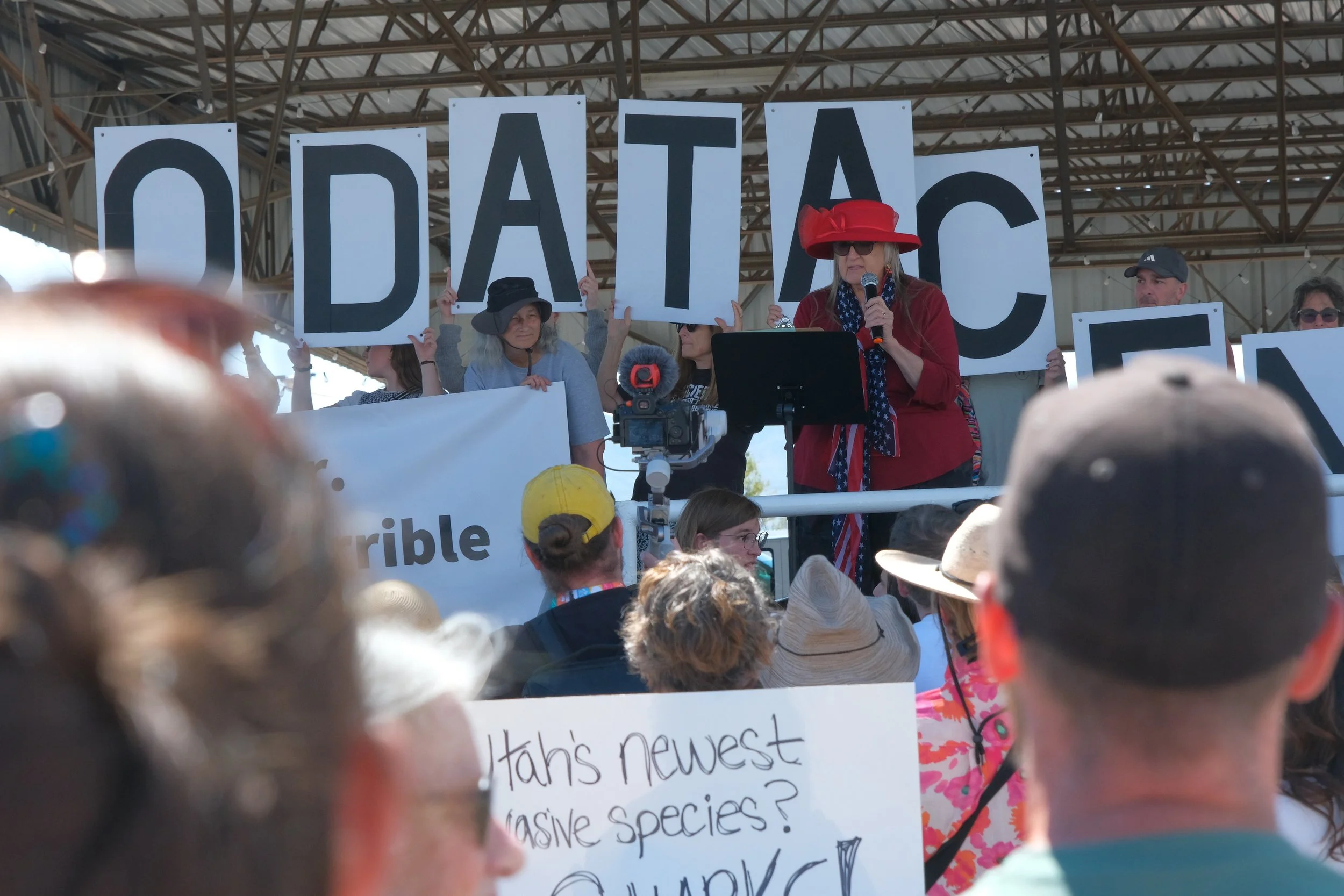 Speakers address a crowd at a rally outside the Box Elder County Fairgrounds before entering the building on May 4.