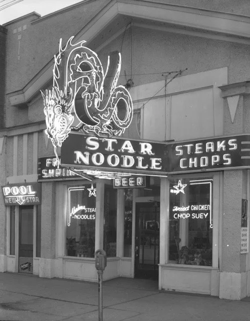 The original Star Noodle at 225 25th St. with neon dragon sign that is now restored and returned to Historic 25th Street.