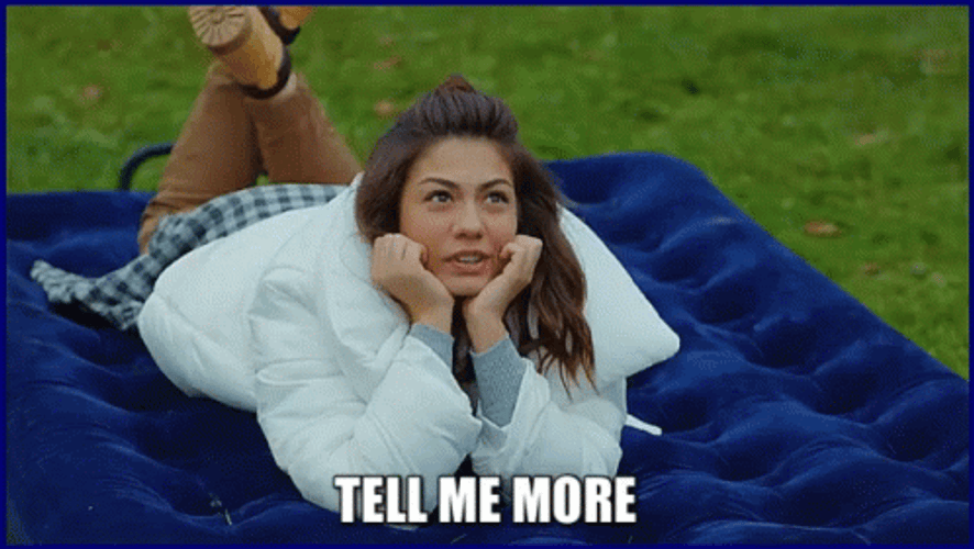 Girl acting cute and asking someone to tell them more.