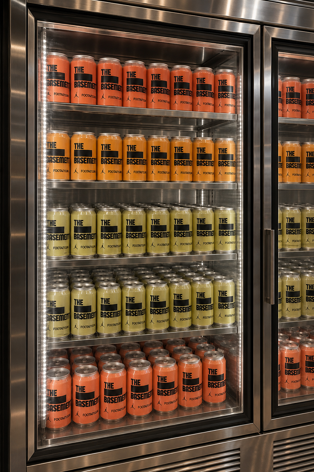 COLOURFUL BRANDED DRINKS CANS ARRANGED IN A REFRIGERATED DISPLAY FOR A CREATIVE BRAND ACTIVATION.