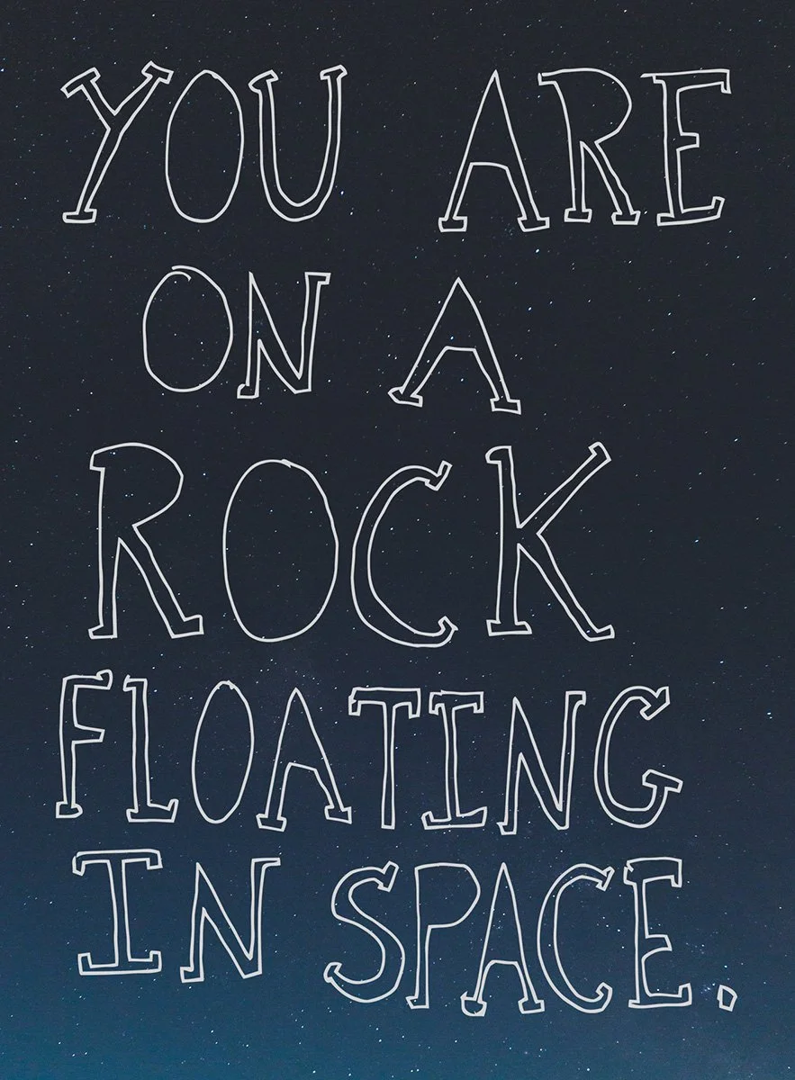 You are on a rock floating in space. A6 postcard by Kate Lloyd.