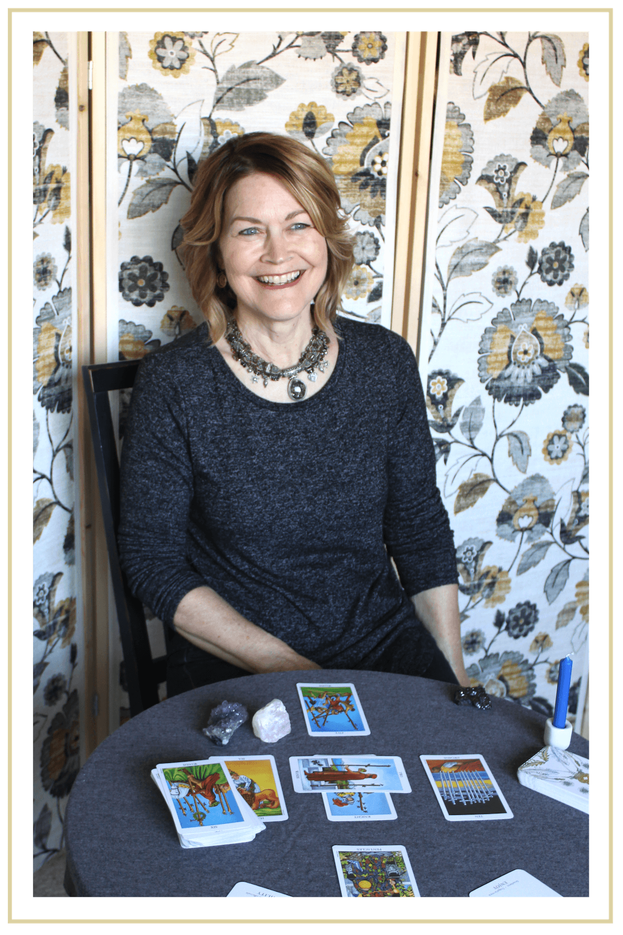 Nancy smiling with tarot cards and yellow boarder-01.png