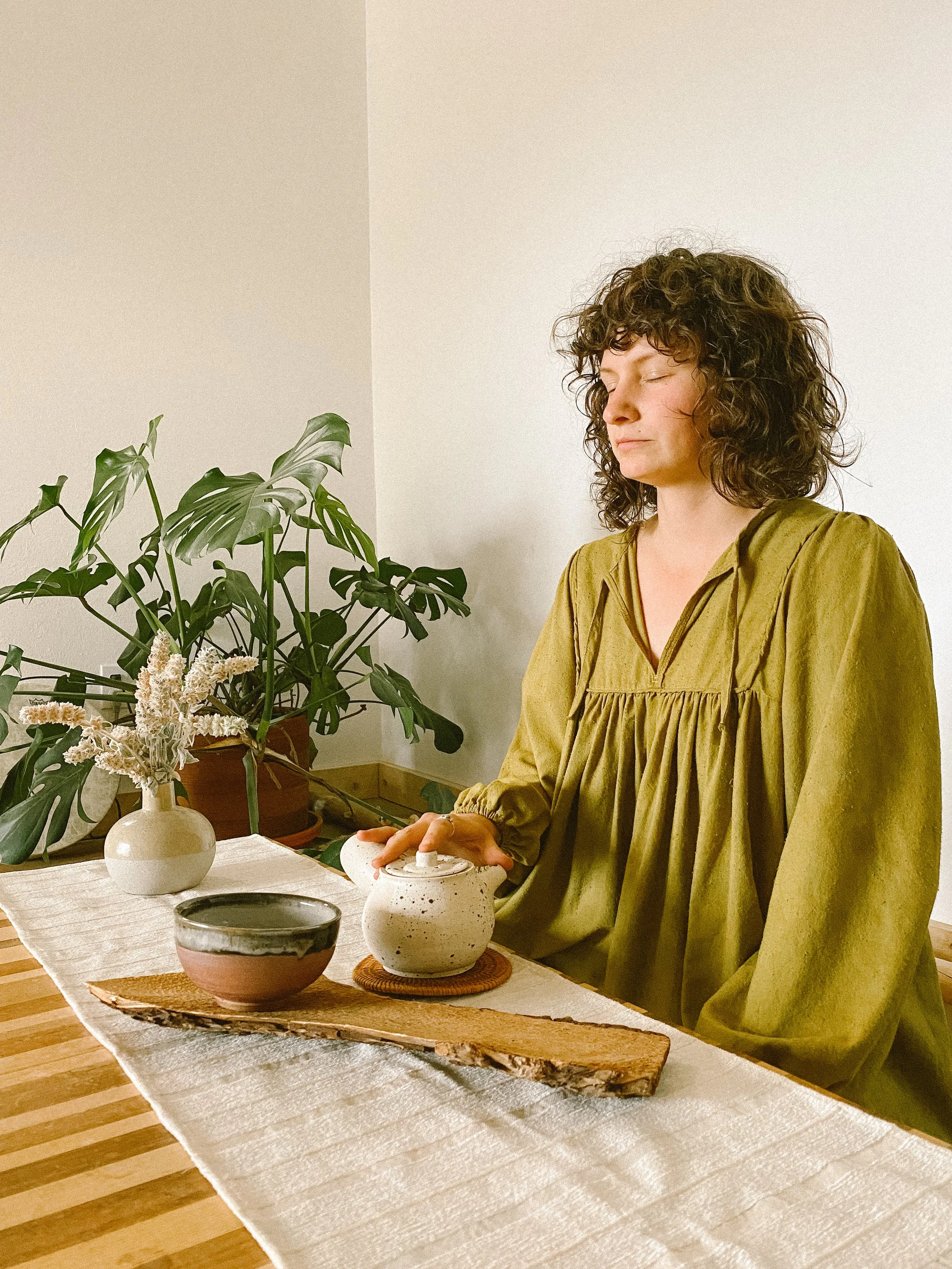 Woman seated on the group in tea ceremony