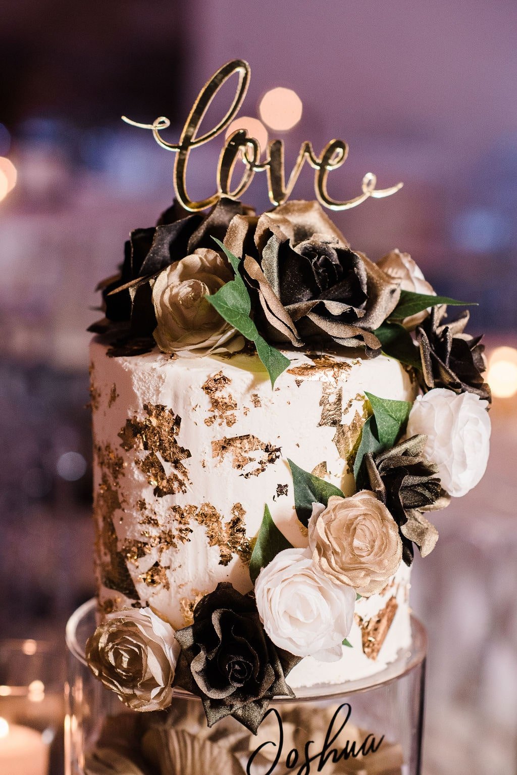 Gold and white wedding cake with real flowers