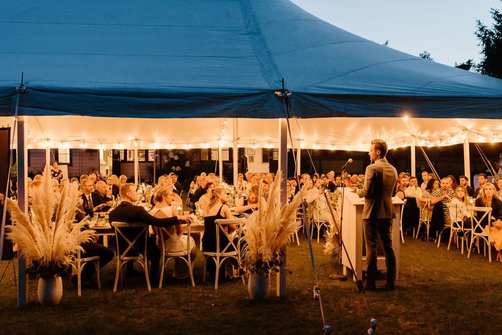Wedding reception in tent with bistro lights