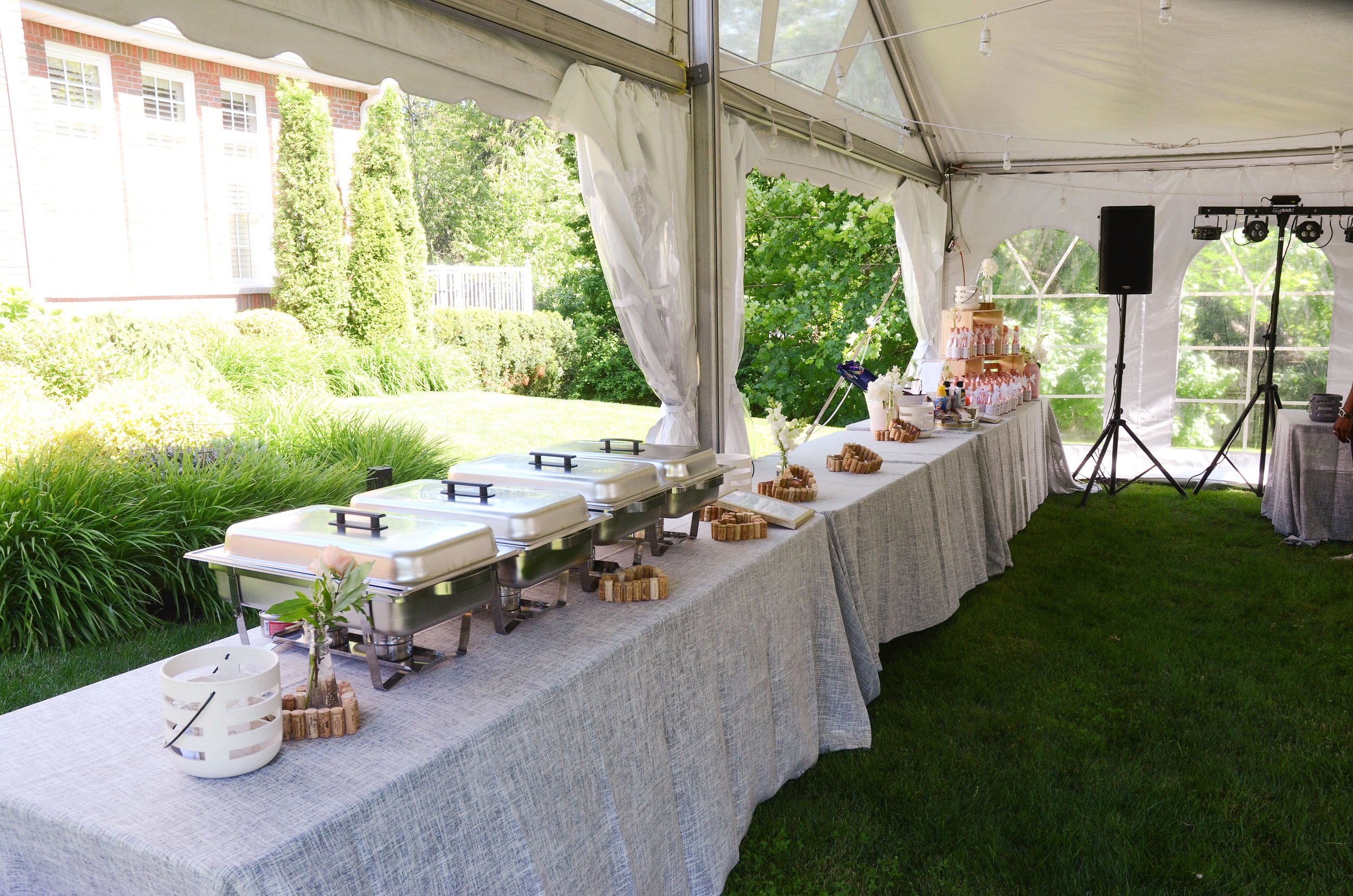 Buffet table at a backyard tented wedding reception