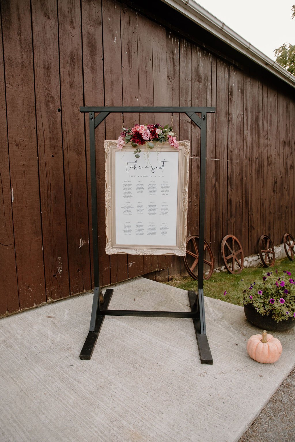 Gold wedding seating chart with flowers