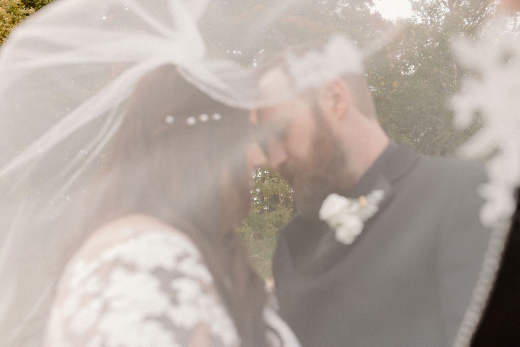 Bride and groom portrait with veil