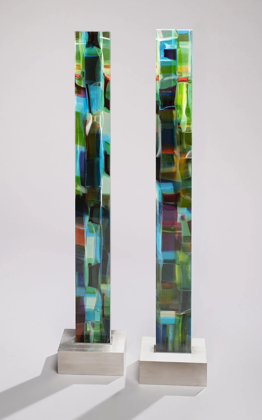 Spire 12 (43 3/4”H x 4 1/2” W x 1 3/4”D) (L) Spire 11 (44”H x 4 1/2” W x 1 3/4”D) (R) set in a brushed stainless steel base (3”H x 8 3/8"W x 6 1/2” D) 