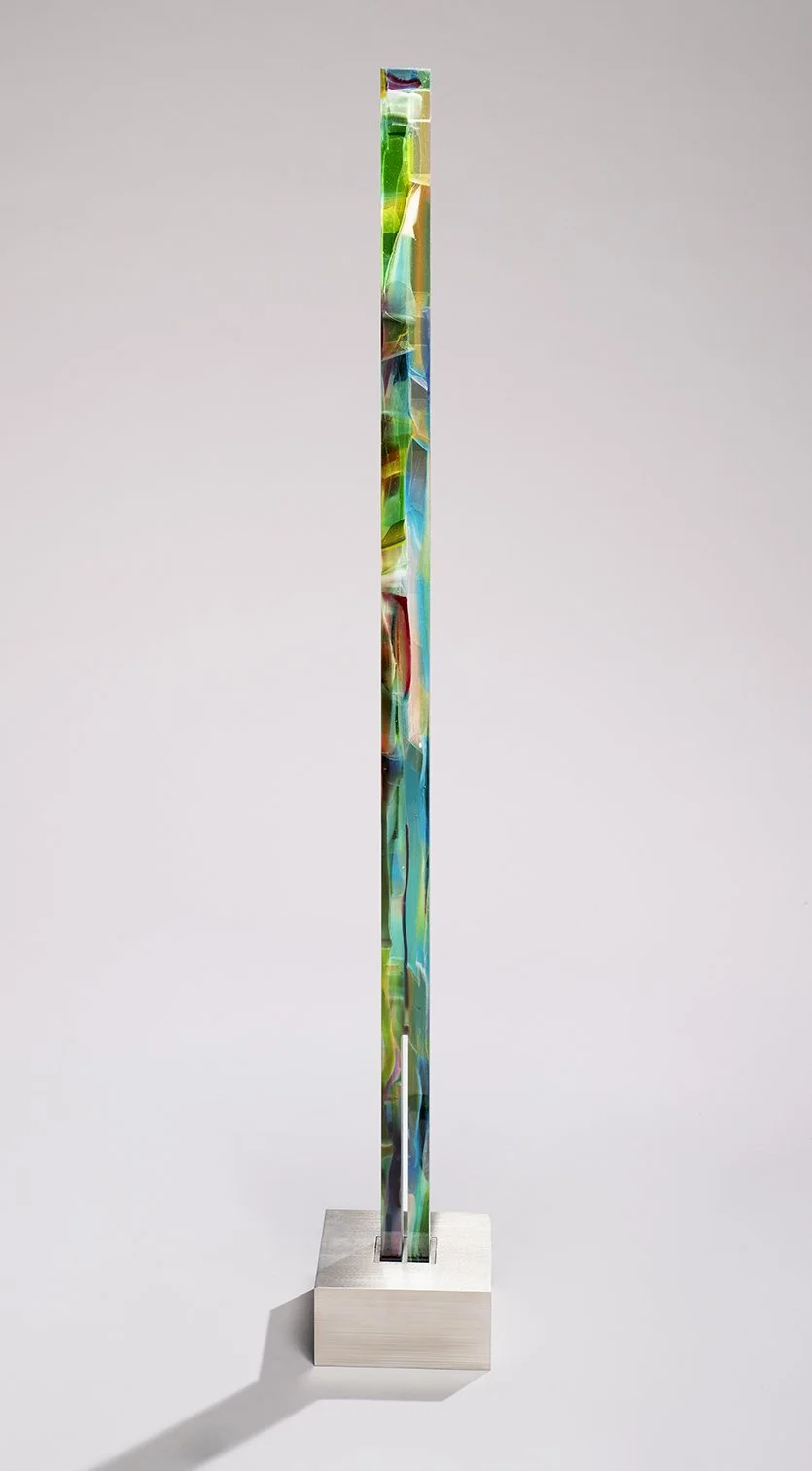 Spire 17 (45 1/2”H x 1 3/4”W x 1 3/4”D) set in a brushed stainless steel base (3”H x 6 1/2"W x 6 1/2” D) 