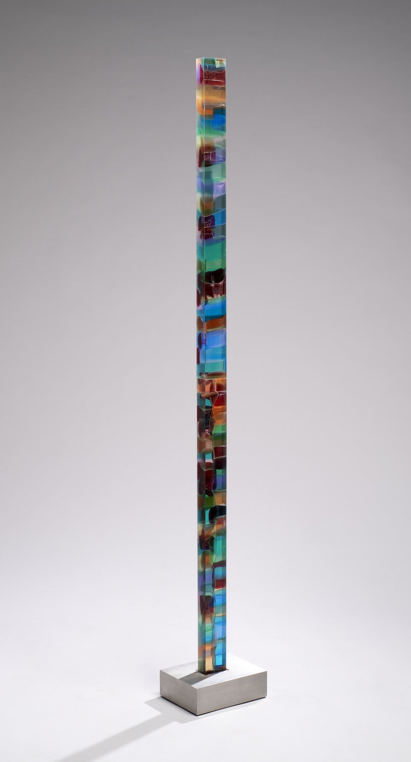 Spire 8 (70 ½” H x 2 7/8” W x 1 ¾” D) set in a brushed stainless steel base( 9 ¾” W x 7 ½” D x 3” H)