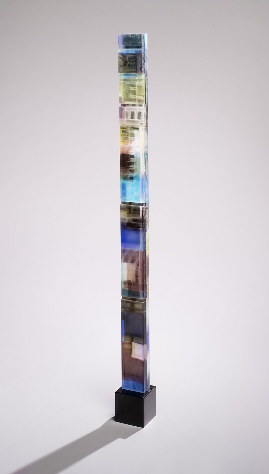 Spire 16 (51”H x 3 3/8”W x 1 3/4”D) set in a blackened steel base (4 1/4”H x 4"W x 4 1/4”D)