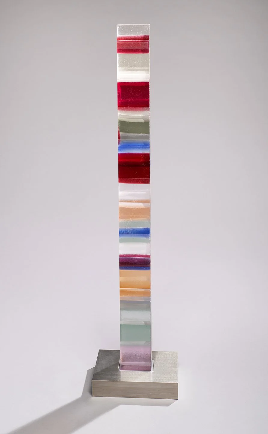 Spire 9 (44”H x 3 3/4” W x 2 5/8”D) set in a brushed stainless steel base (2”H x 10"W x 8” D)