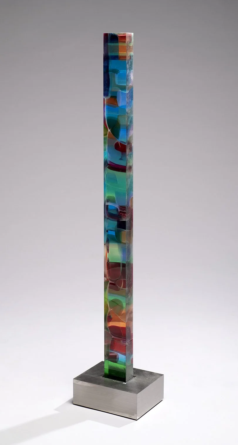 Spire 5 (41 ¾” H x 2 7/8” W x 1 ¾” D) set in a brushed stainless steel base (8 1/2” W  x 6 ½” D x 3” H)