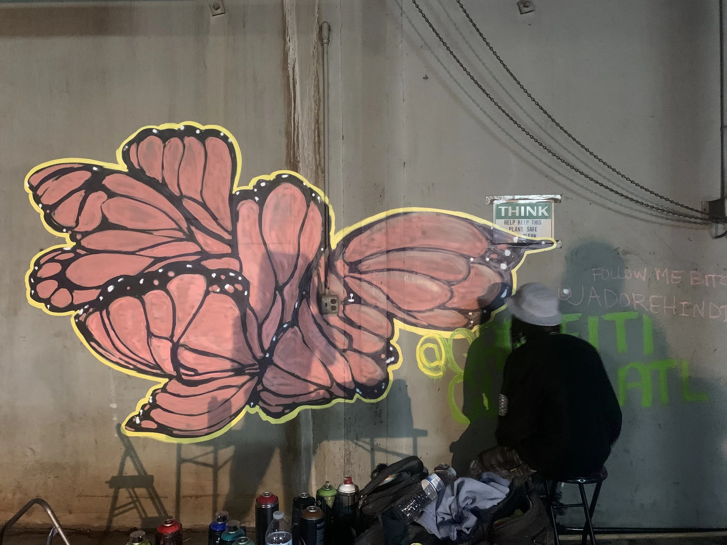 signing the butterfly wall mural at bonfire atl event space