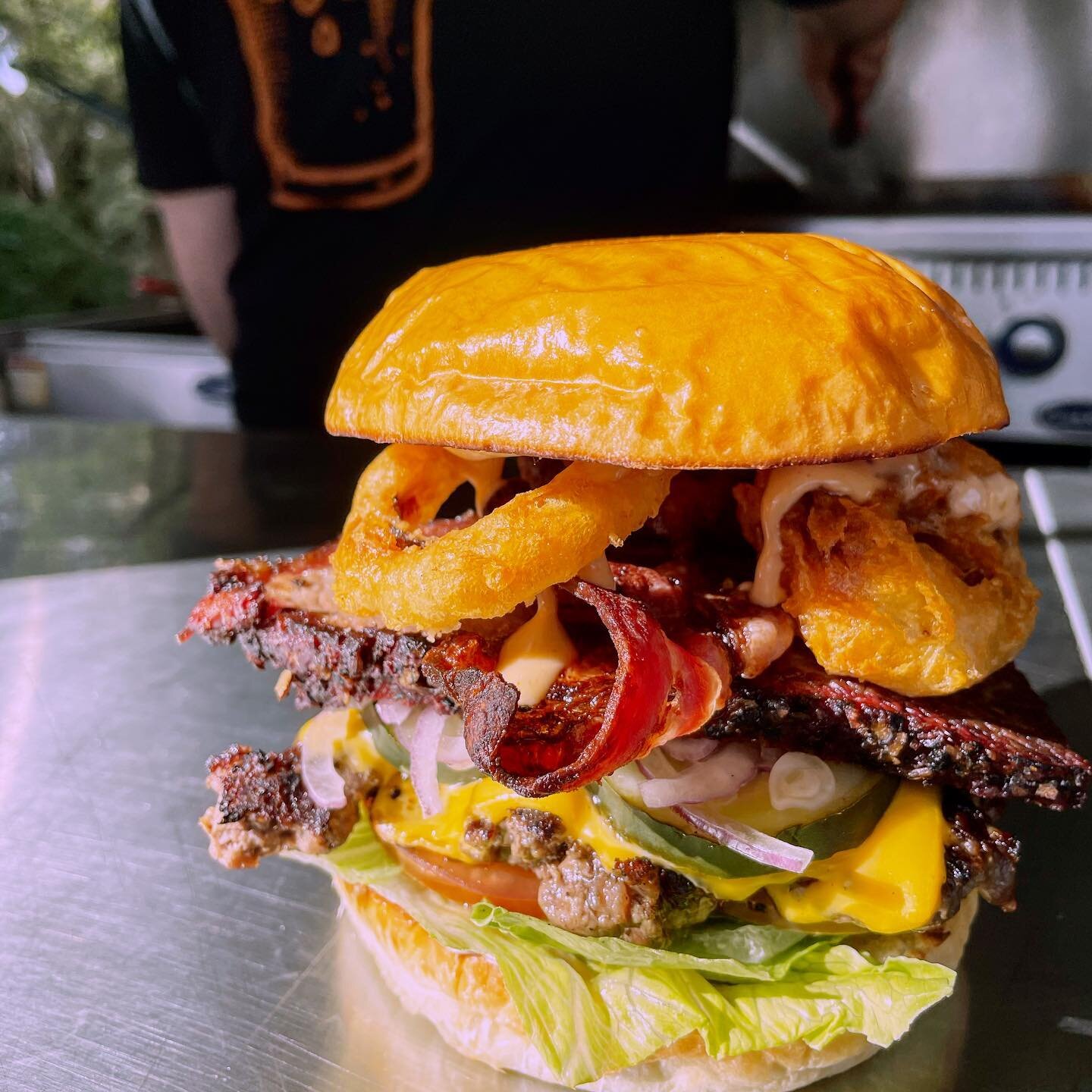 Speak easy burger this weekend is the kitchen sink burger! It&rsquo;s got a little bit of everything. Smoked brisket, onion rings, special sauce all on the back of an O.G. base. It&rsquo;ll make you want to slap ya mama.