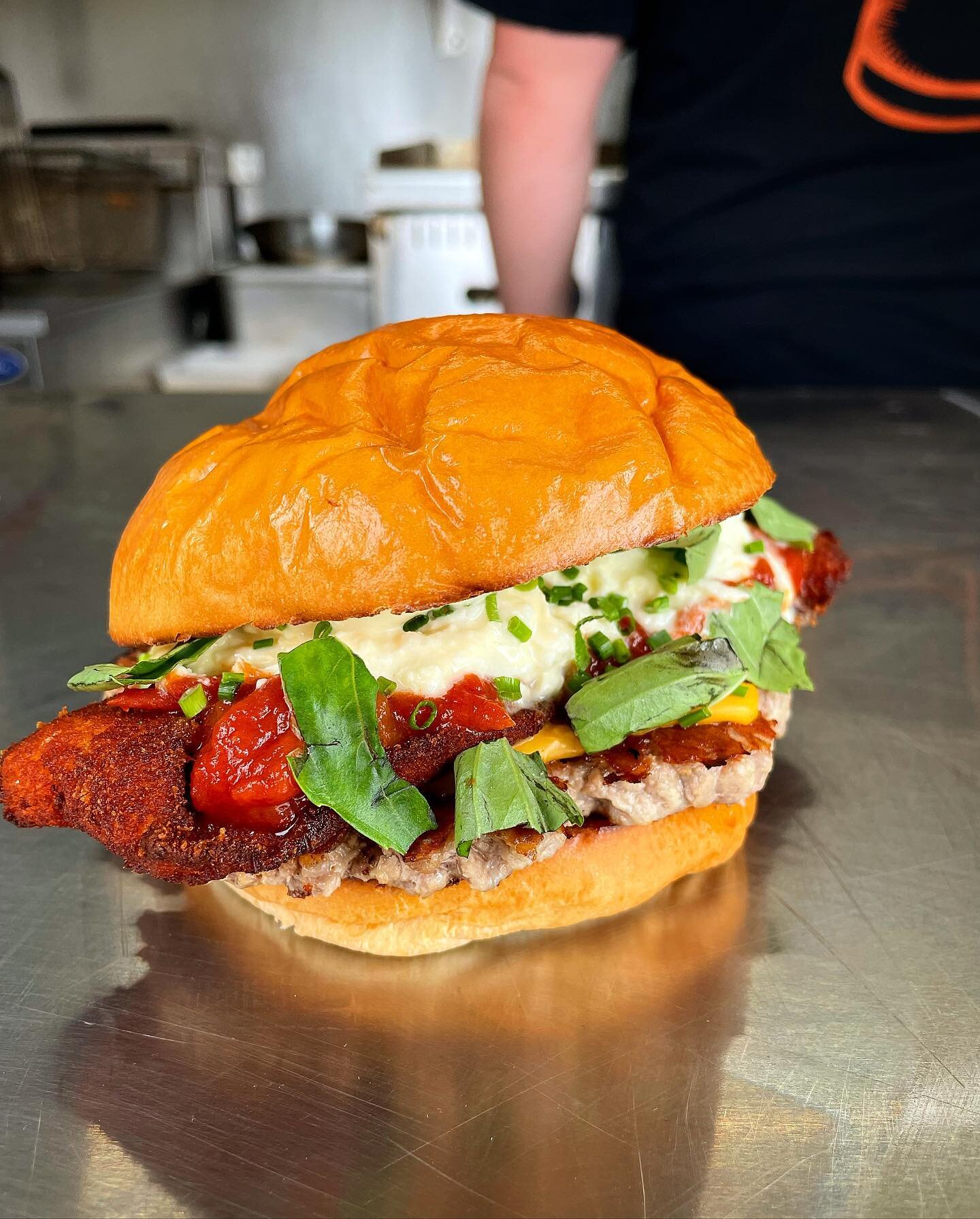 This weekend's speak easy burger is sure to keep you warm even if life's pretty schnitty right now! The Parmadrama burger has a whopping chicken schnitzel, pork patty, Napoli sauce, stracciatella cheese and aioli dressing, all packed between two warm