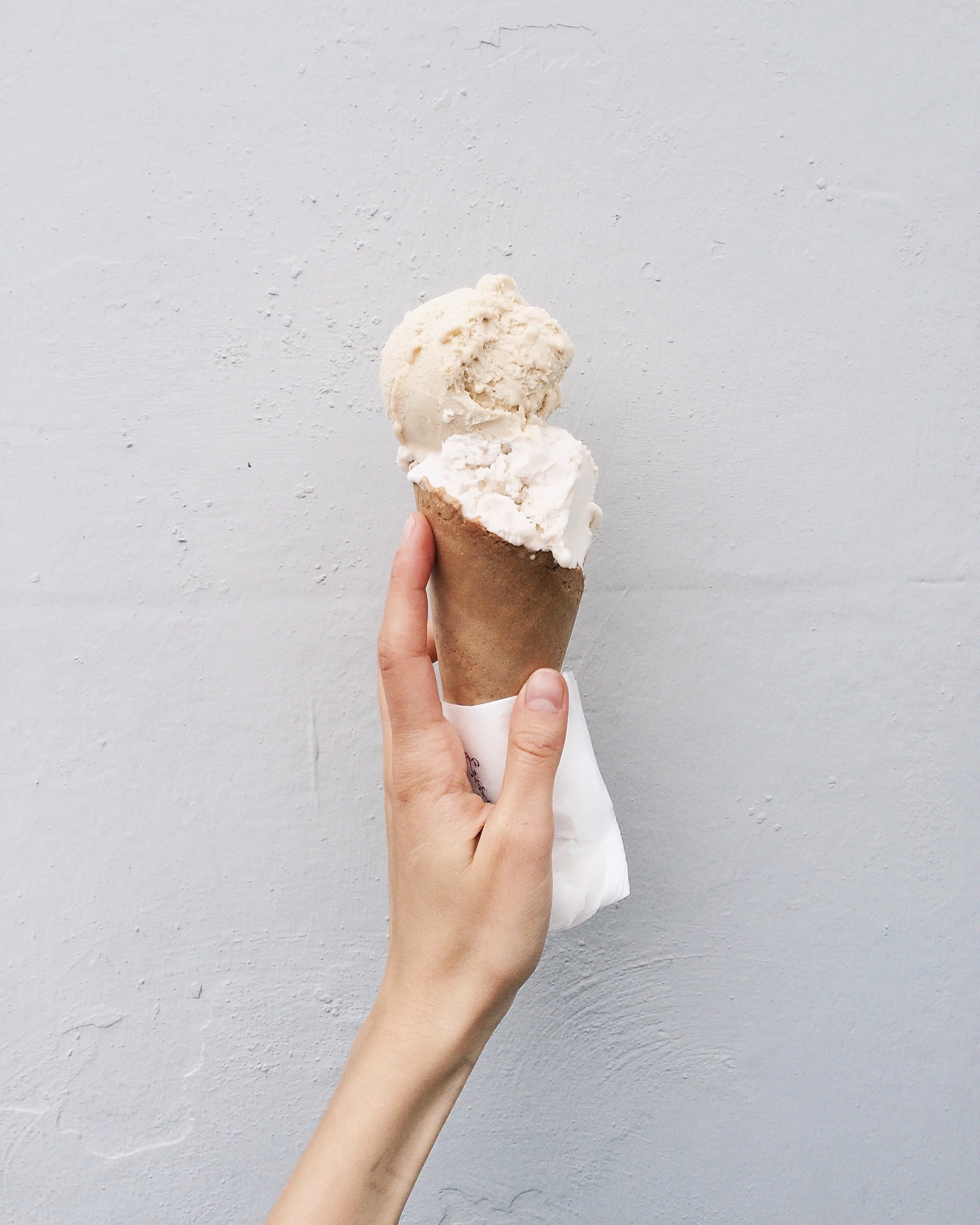 White hand holding ice cream cone freedom from dieting