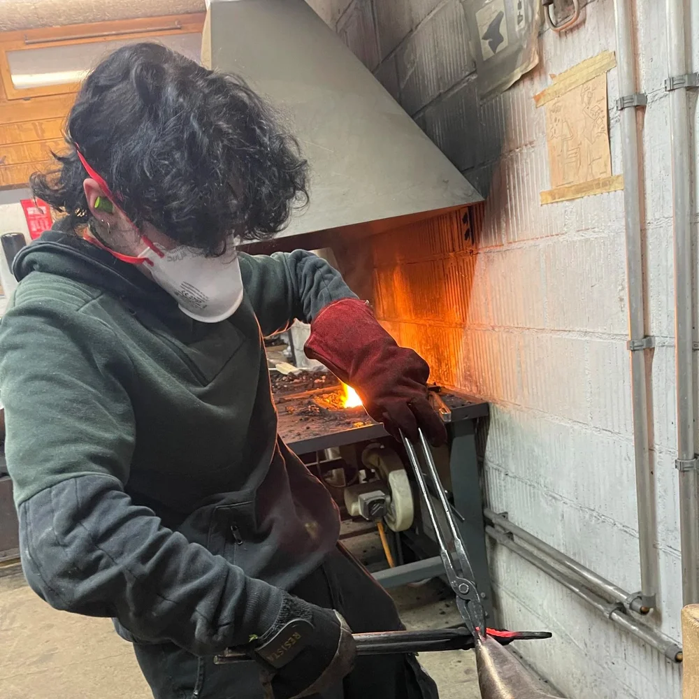 Student blacksmithing