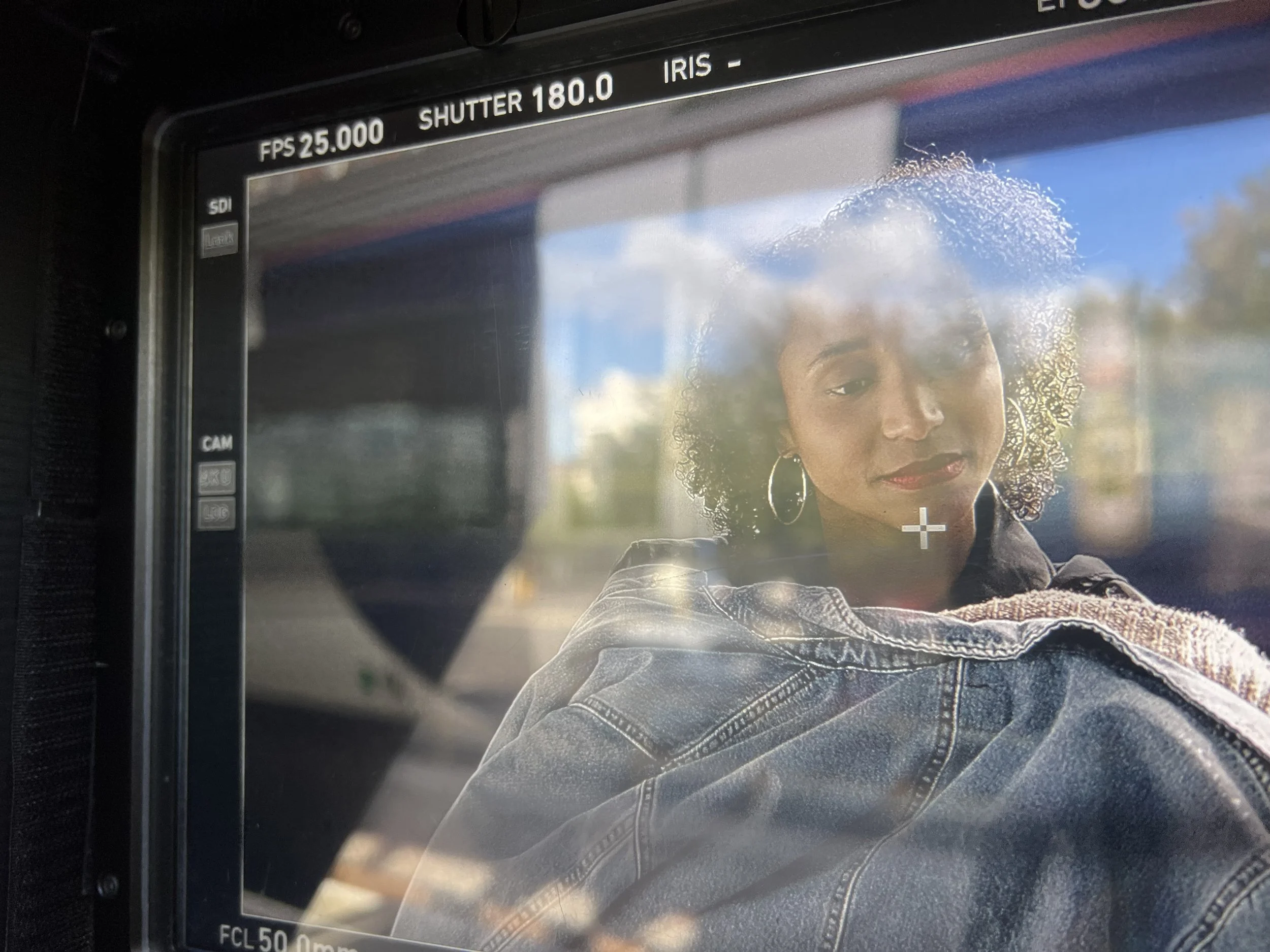 The actor playing Viv, as seen from behind the camera lens