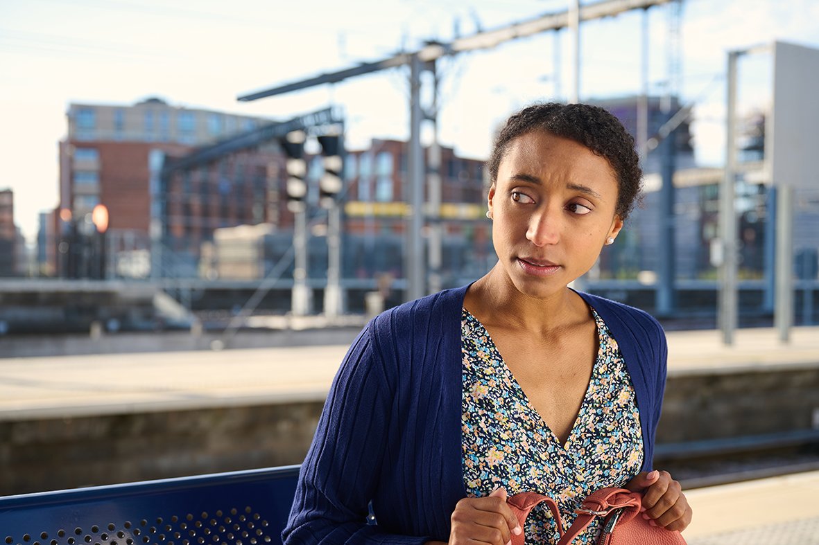 'Viv 2' from Small Talk Saves Lives sits on a platform bench
