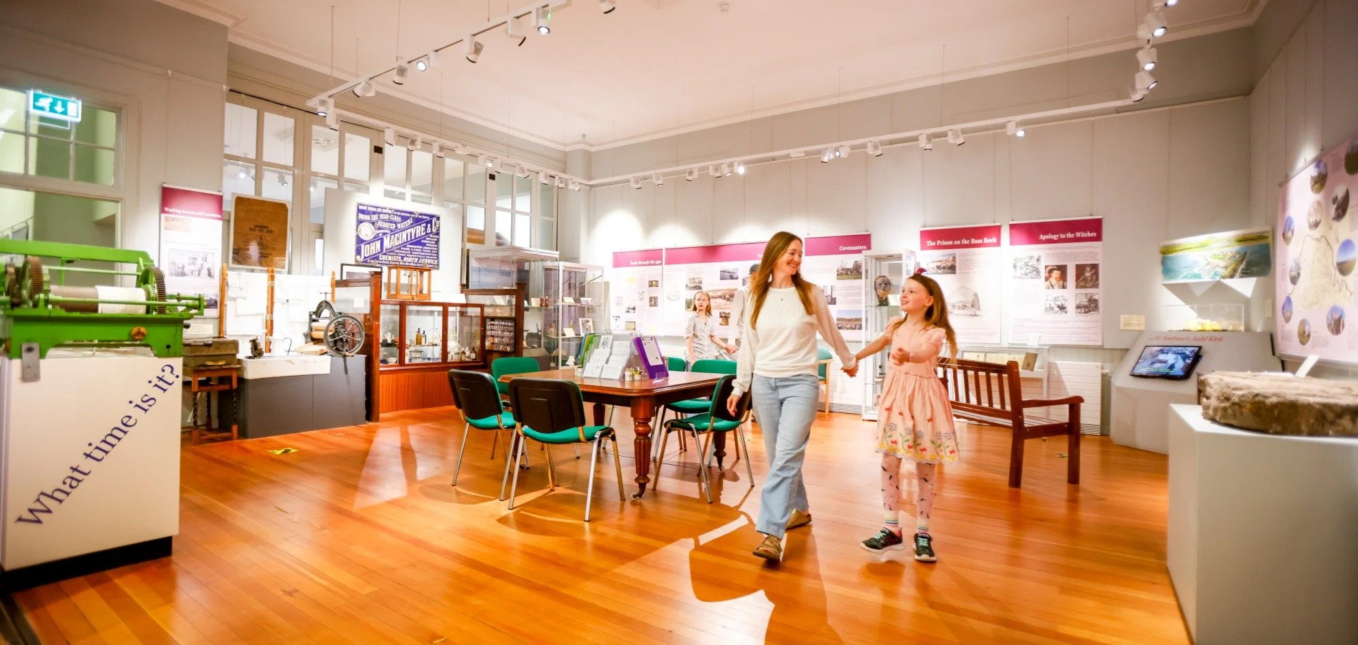 Mother and daughter walking through the Coastal Communities Museum in North Berwick